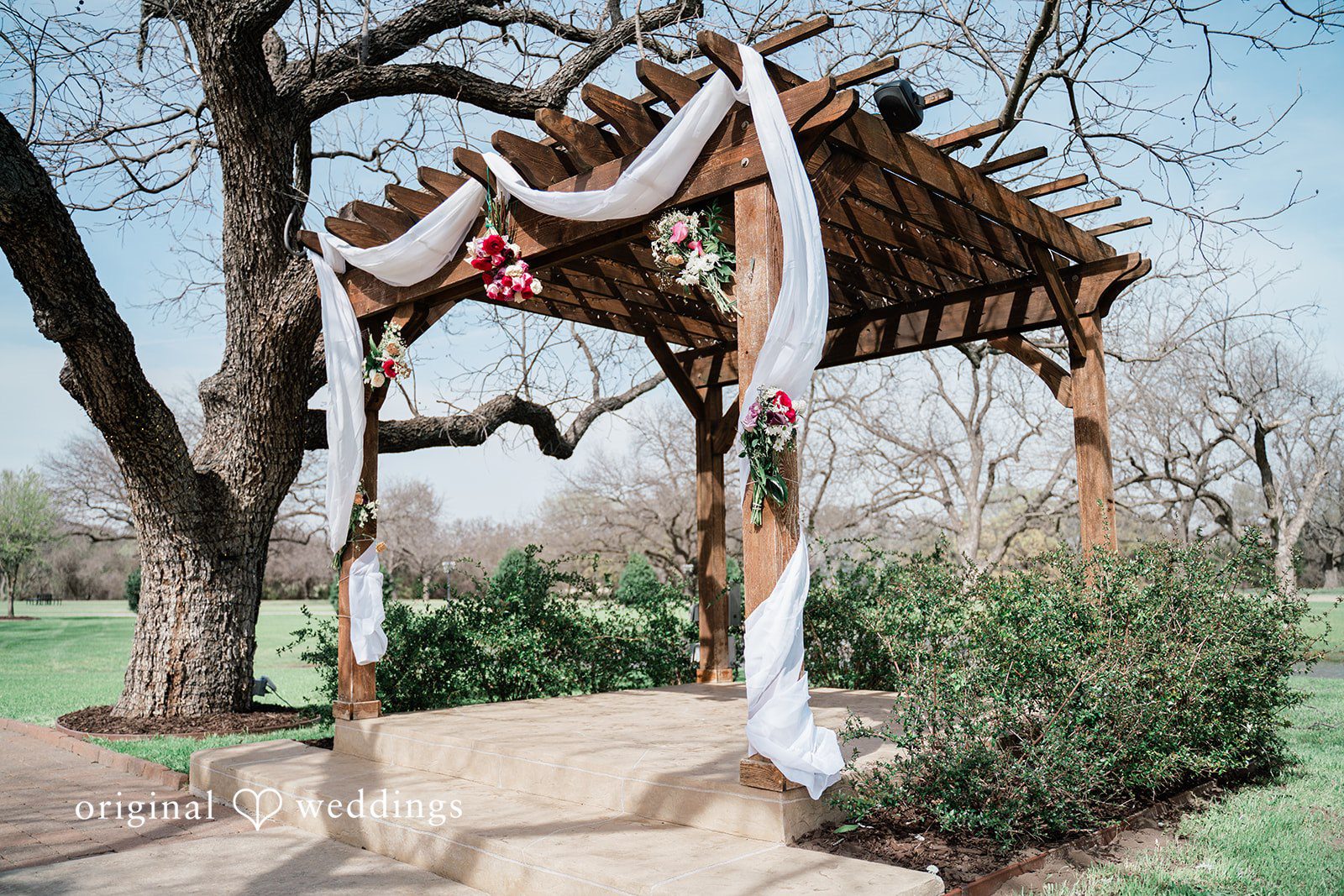 The wedding ceremony arch and beautiful ambience at The Orchard Event Venue & Retreat