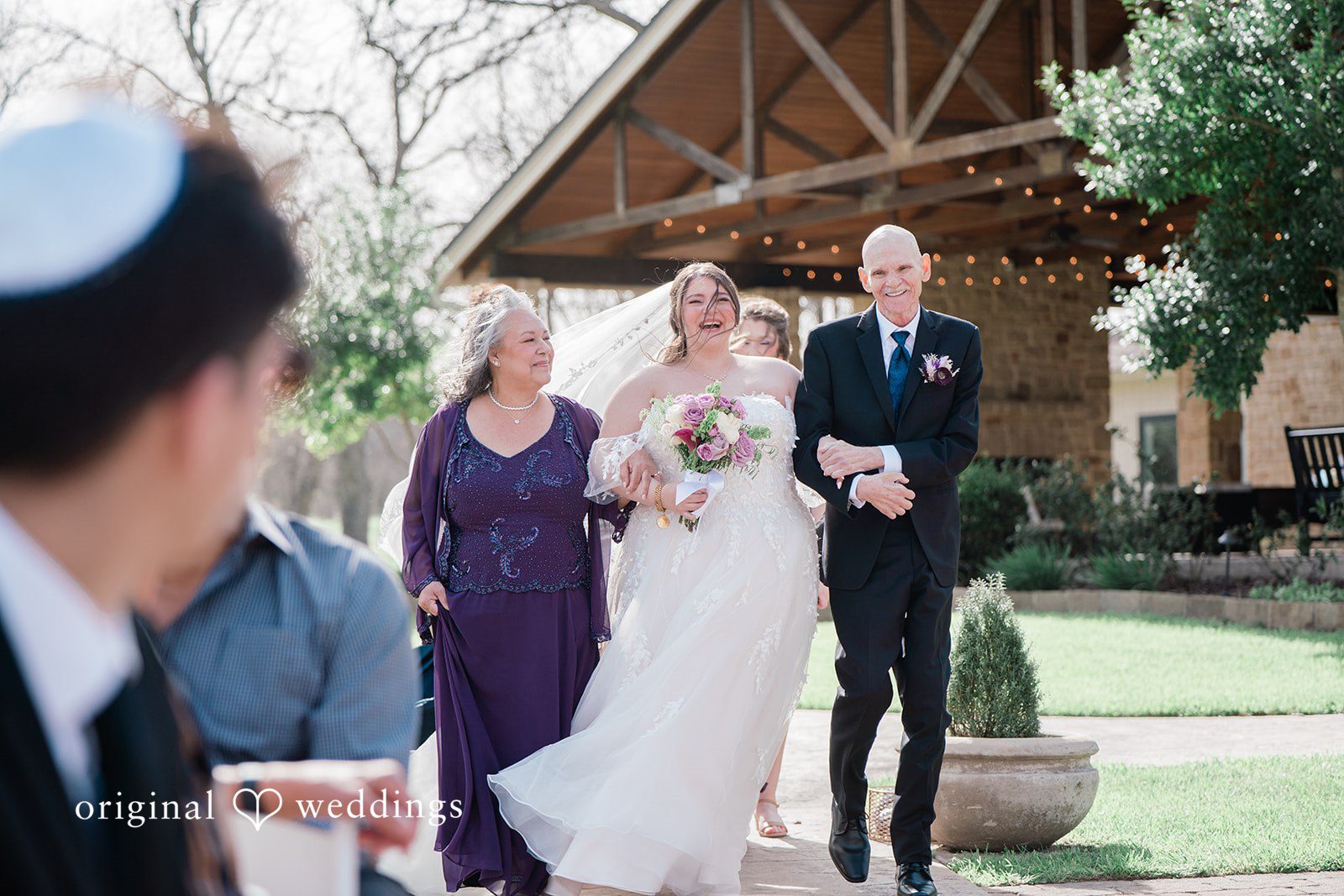 Bride's parents walk the bride down the aisle