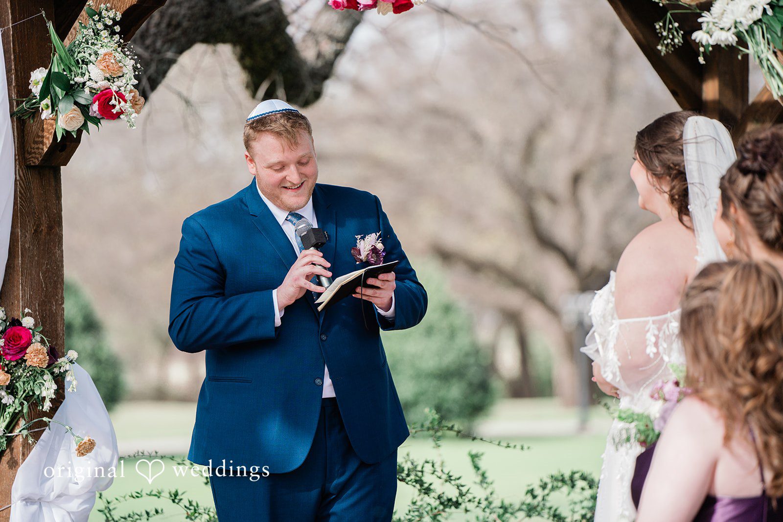 The groom reads his vows to the bride