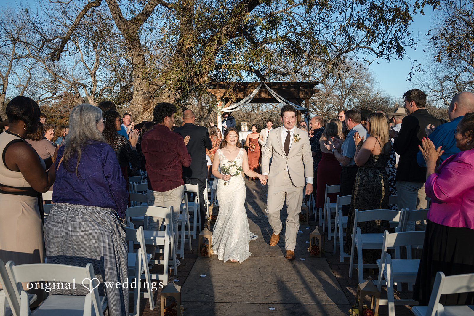 Bonnie + Aksel Romantic bride and groom exit moment at The Orchard Event Venue & Retreat