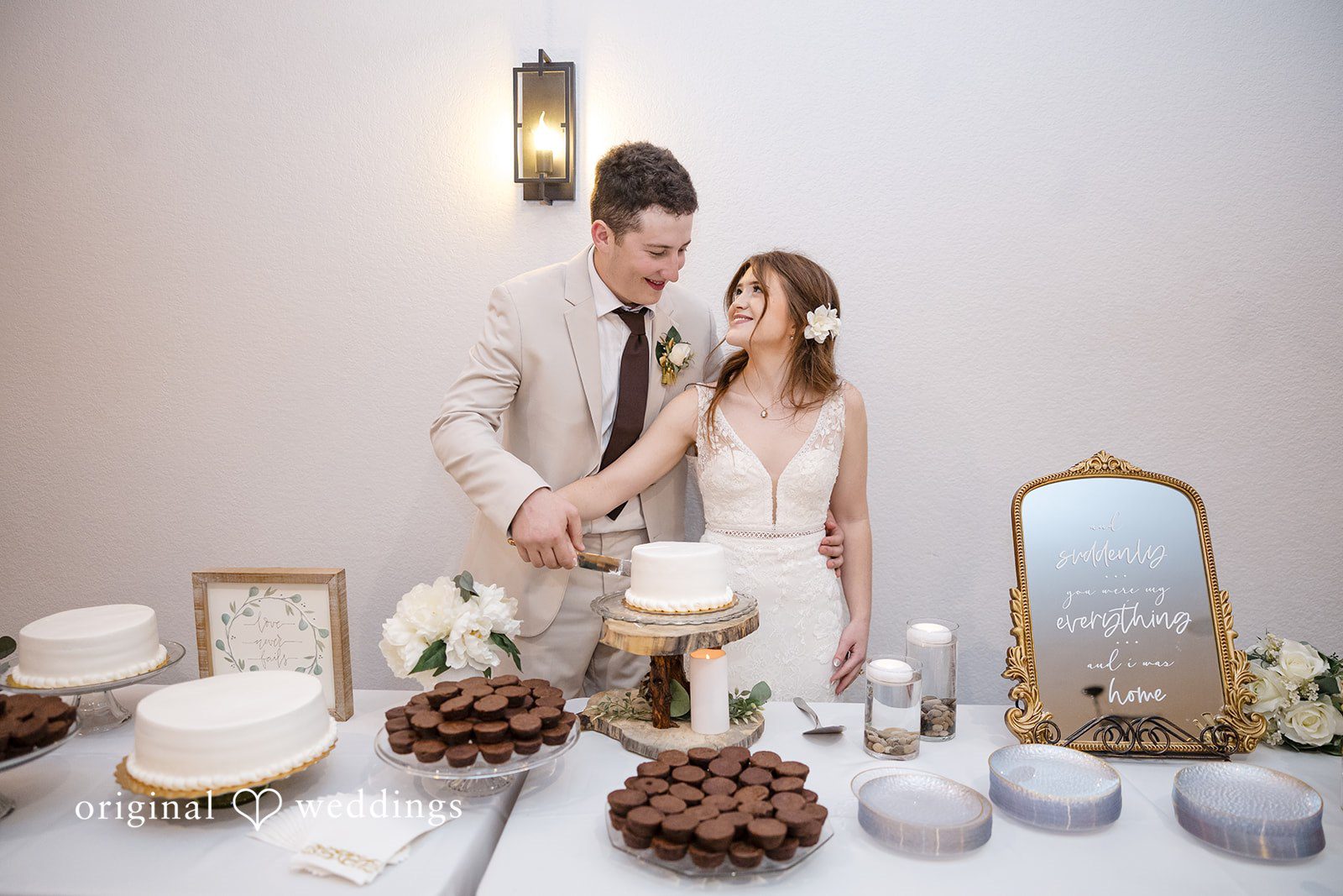 Bonnie + Aksel Dallas Wedding Photographers capturing couple cutting wedding cake at The Orchard Event Venue & Retreat by Original Weddings