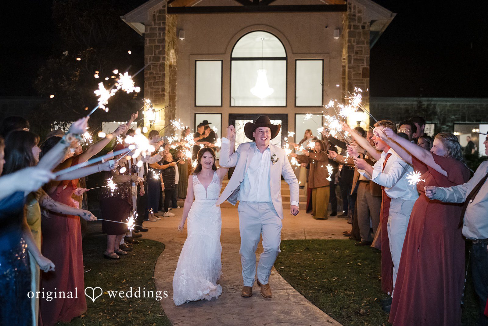 Bonnie + Aksel Dallas Wedding Photographers capturing smiling couple walking exit shot at The Orchard Event Venue & Retreat by Original Weddings