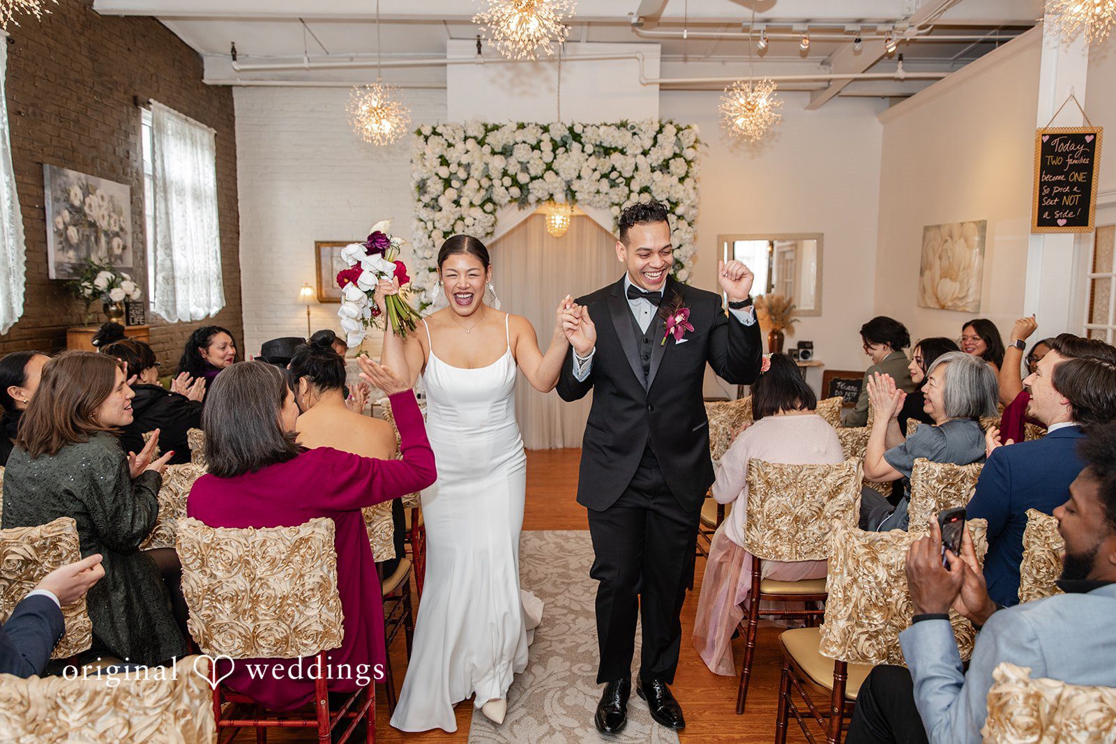 Amanda + Emmanuel Bride and groom celebrating while walking down the aisle together.