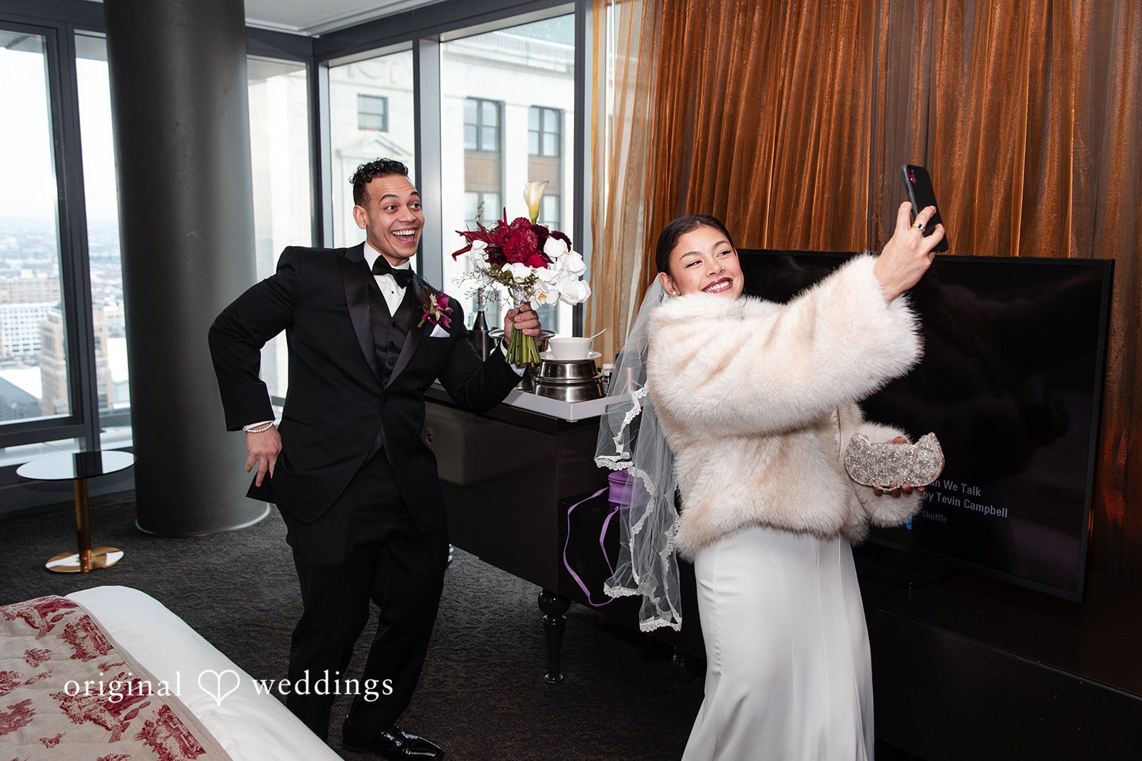 Amanda + Emmanuel Bride taking a selfie while the groom strikes a playful pose.