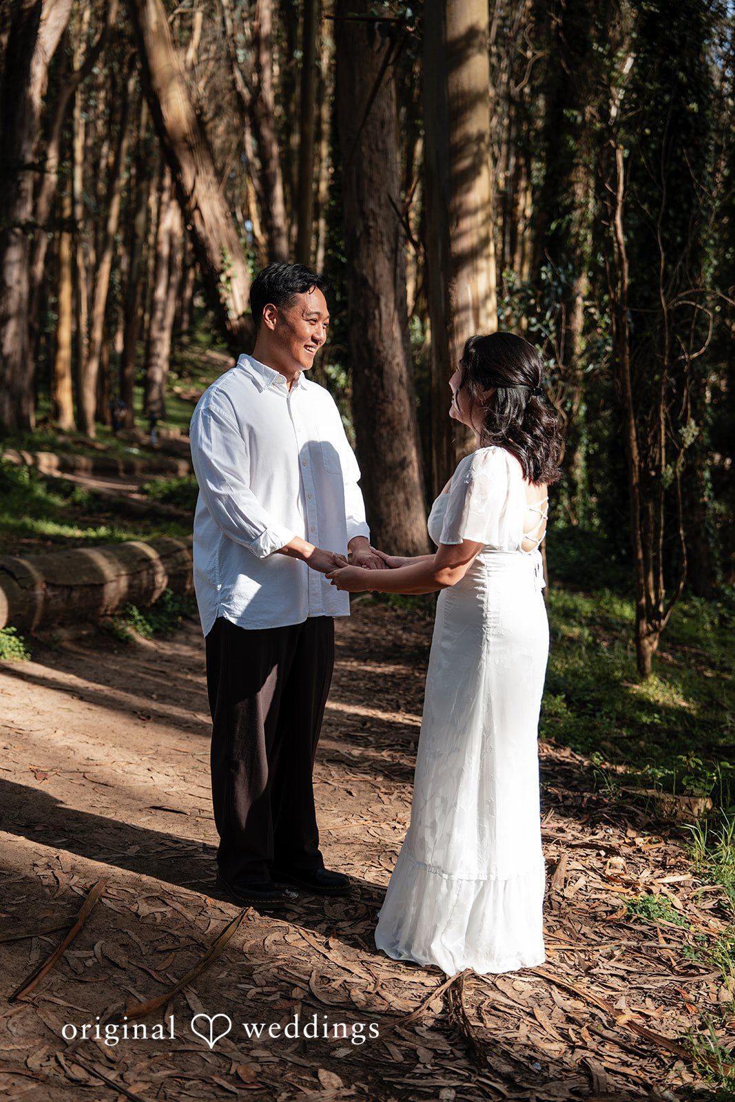 Engaged couple smiling and holding hands