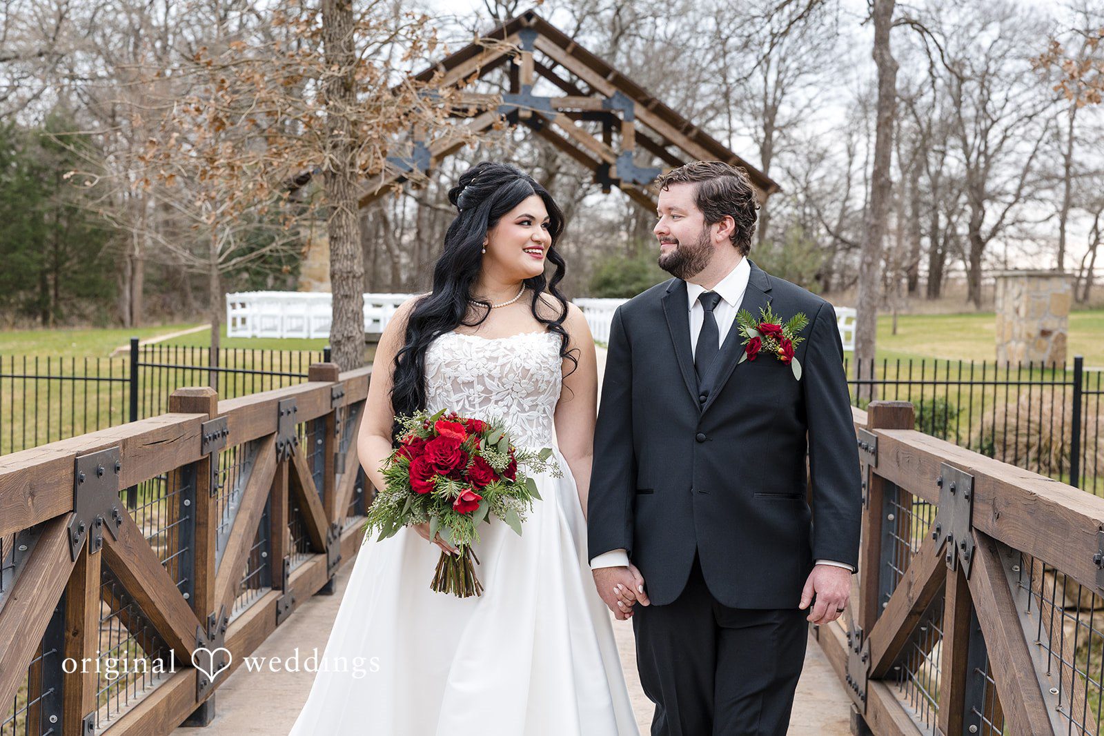 Bride and groom walking on bridge