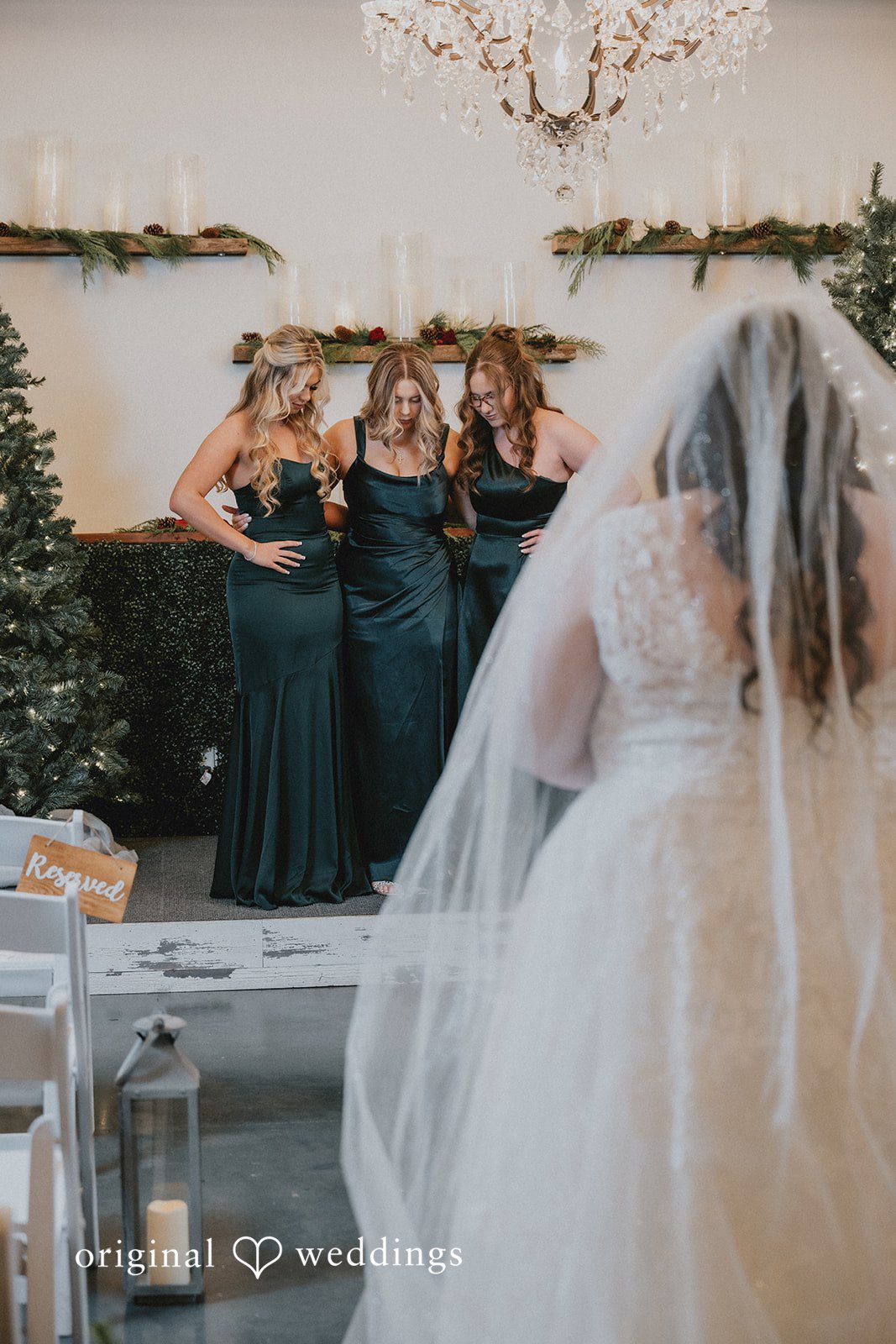 The bride unveils herself to her bridesmaids