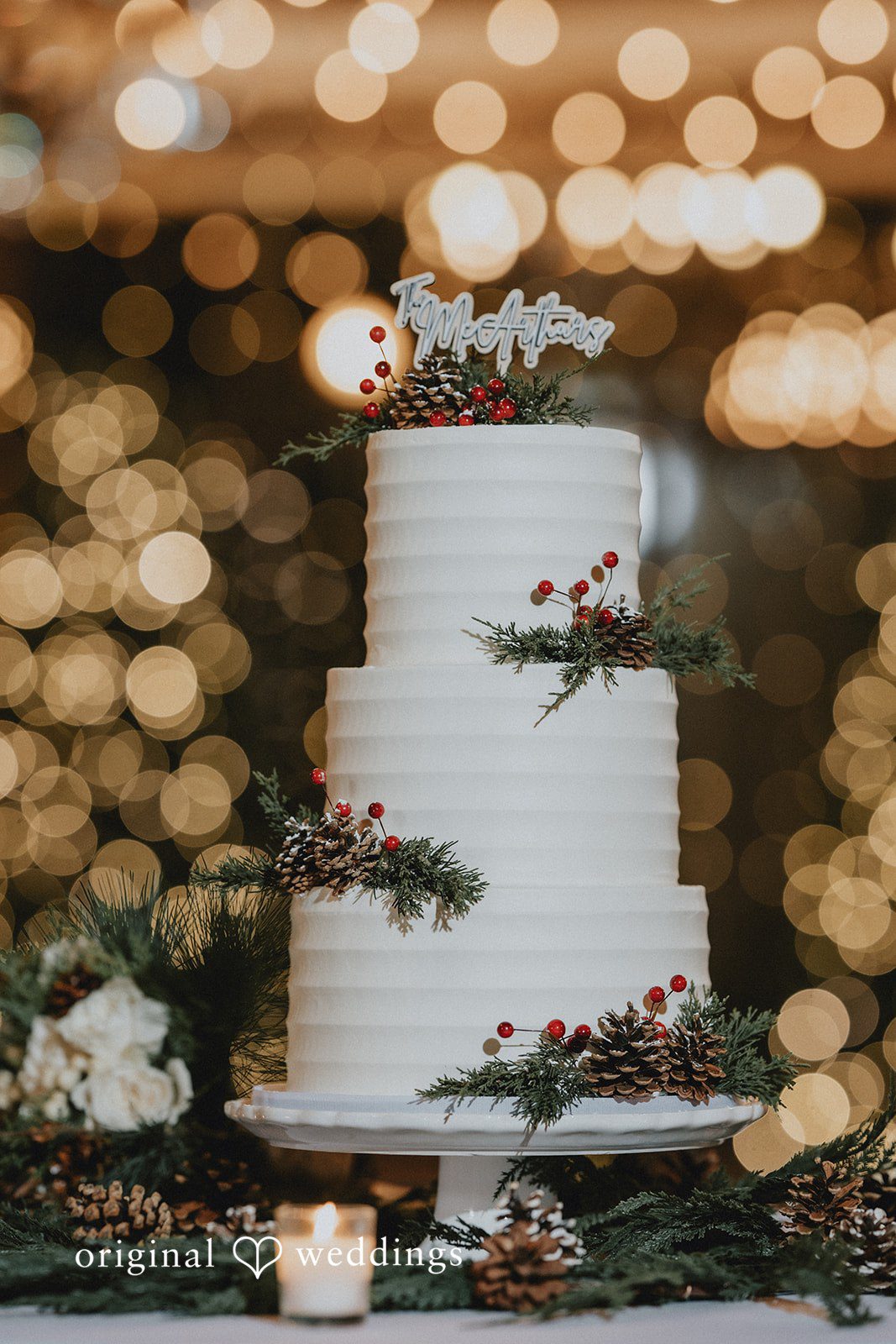An all-white wedding cake adorned with delicate florals