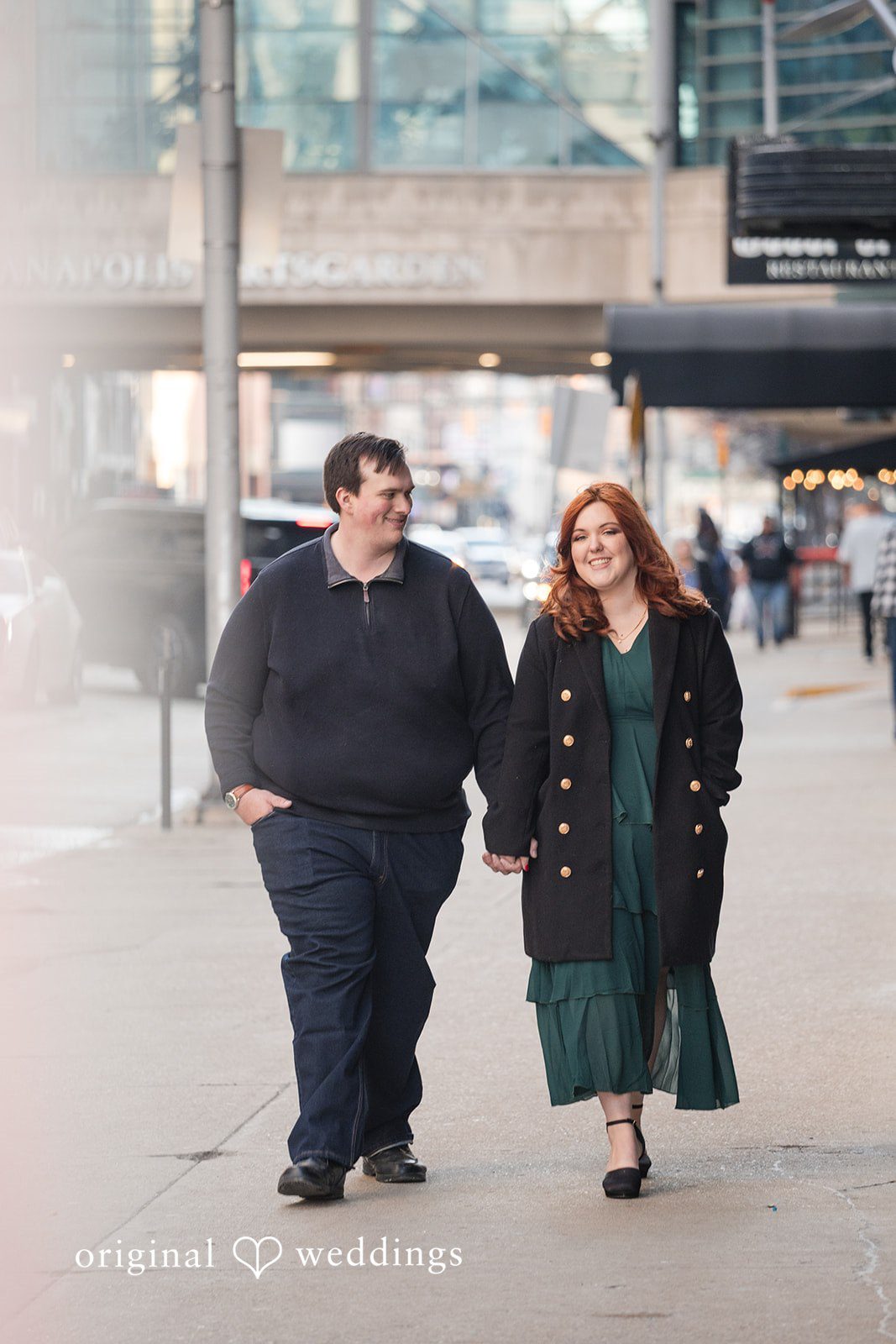 Couple walking hands in hands during photo session