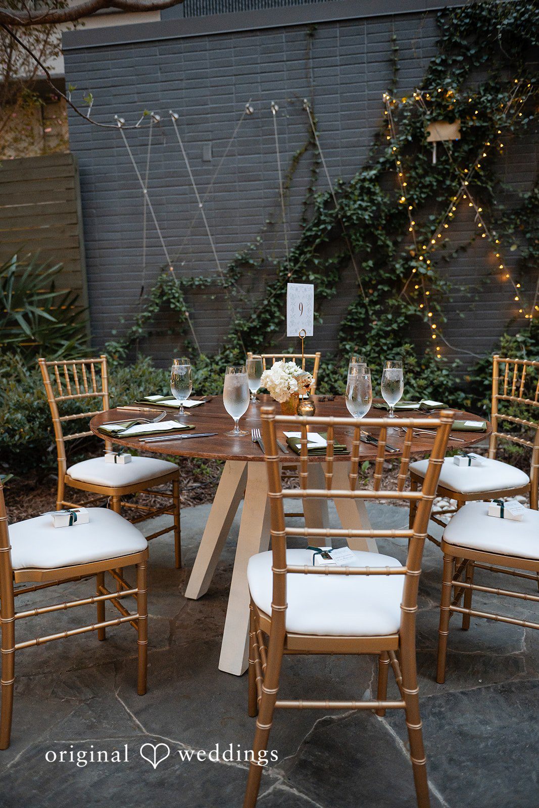 Paola + Jeremy Reception table setup with candles and floral decor