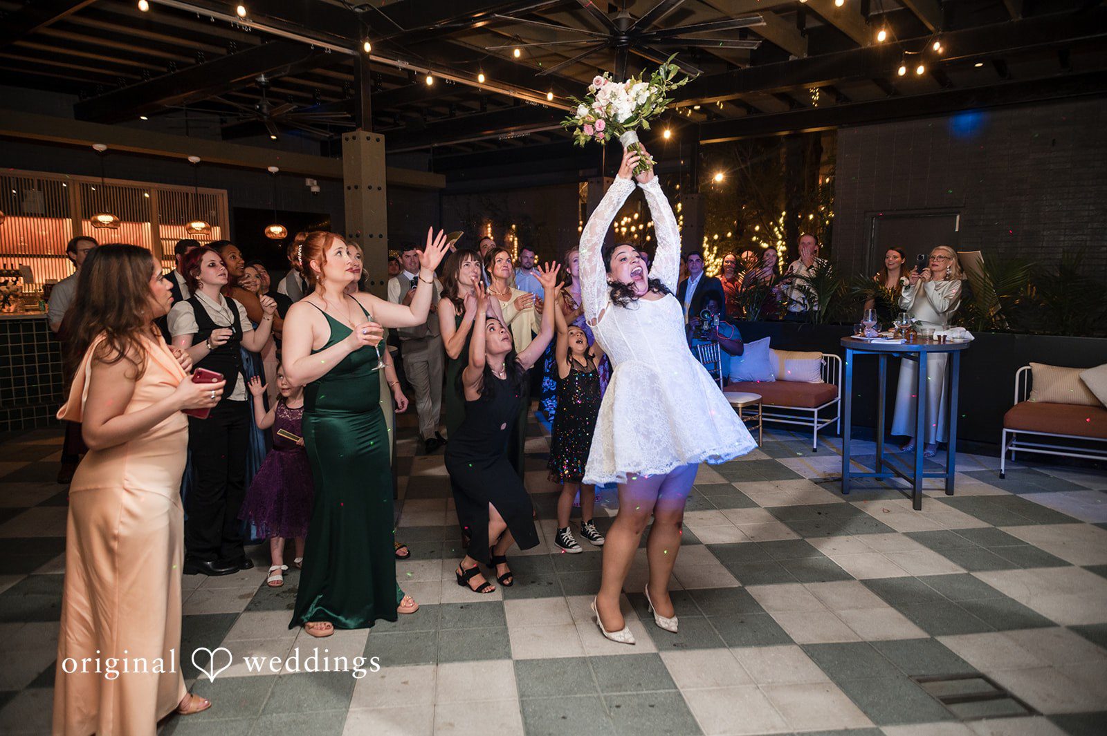 Paola + Jeremy Bride lifted in the air during a fun reception dance moment