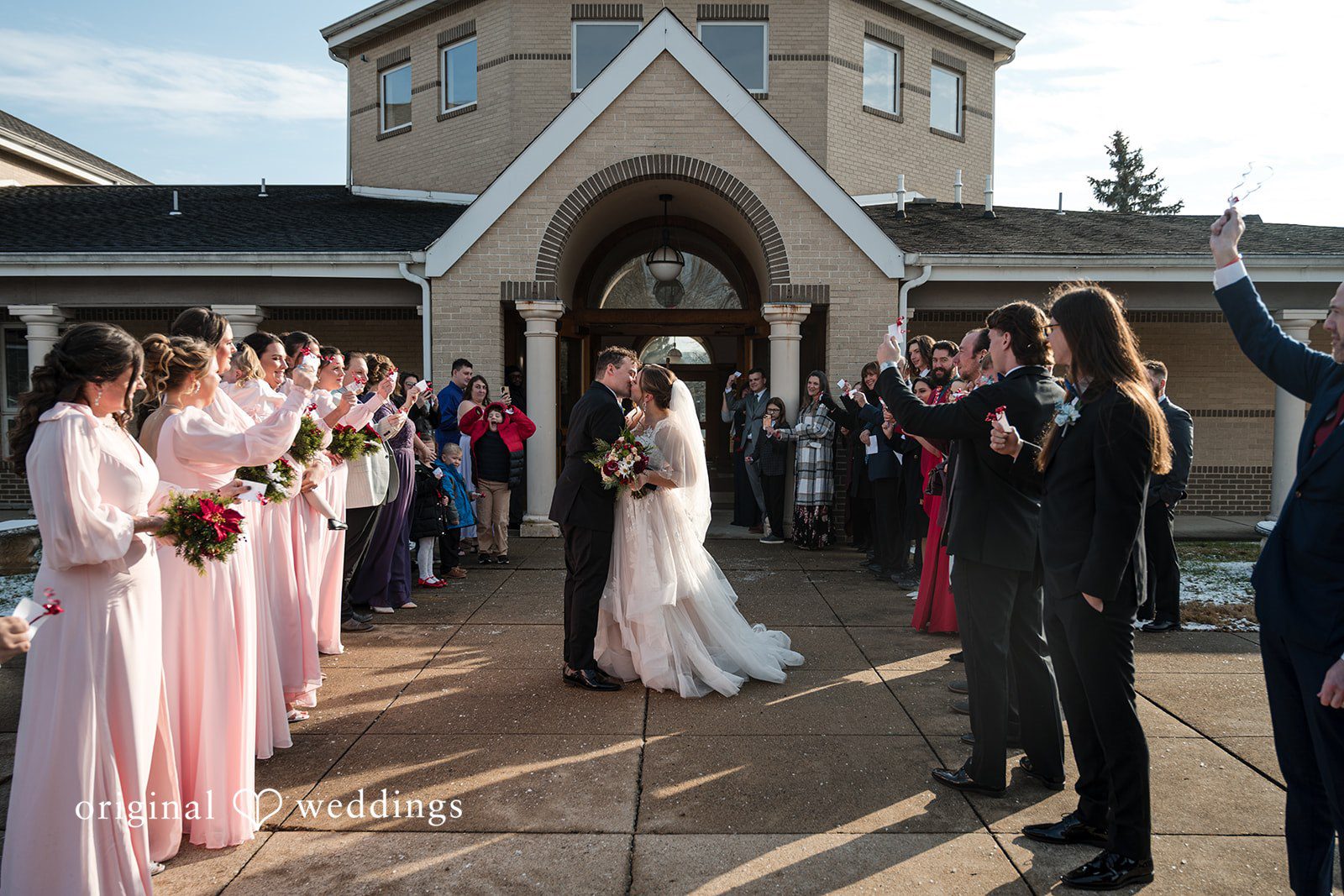 Michael + Shannon The couple takes a romantic kiss with cheers from their wedding party