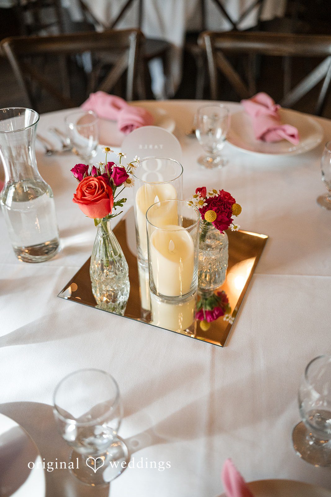 Taylor + Yash Wedding table decorated with candles and flowers at The Troutdale House