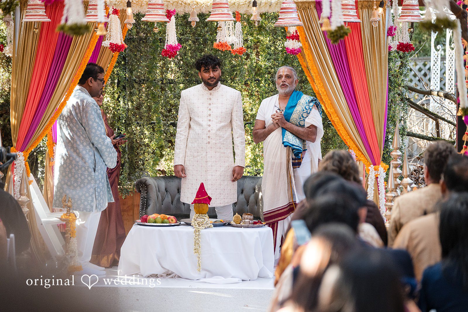 Taylor + Yash Groom and priest captured during ceremony