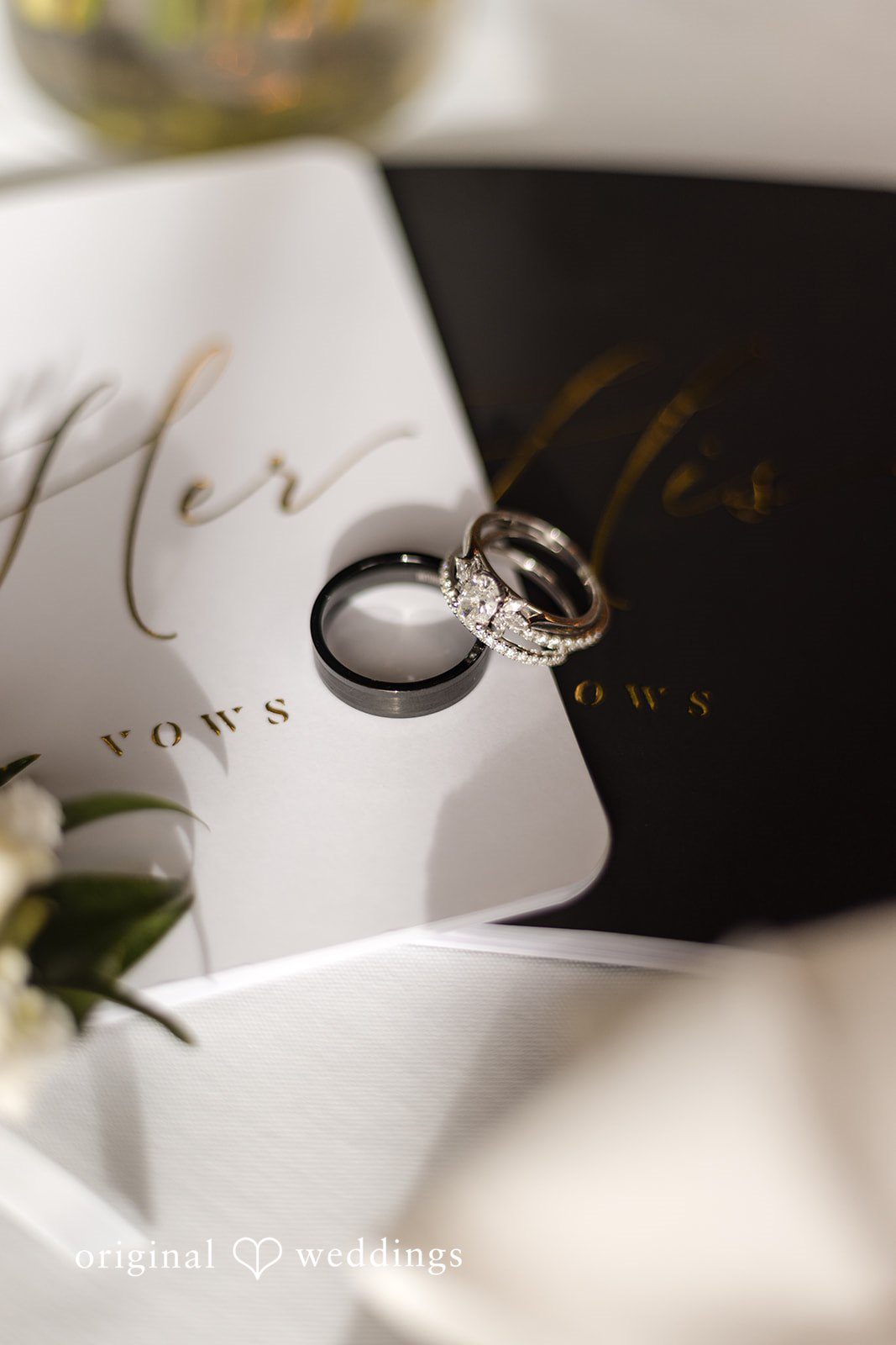 Close-up of wedding rings styled on vows details