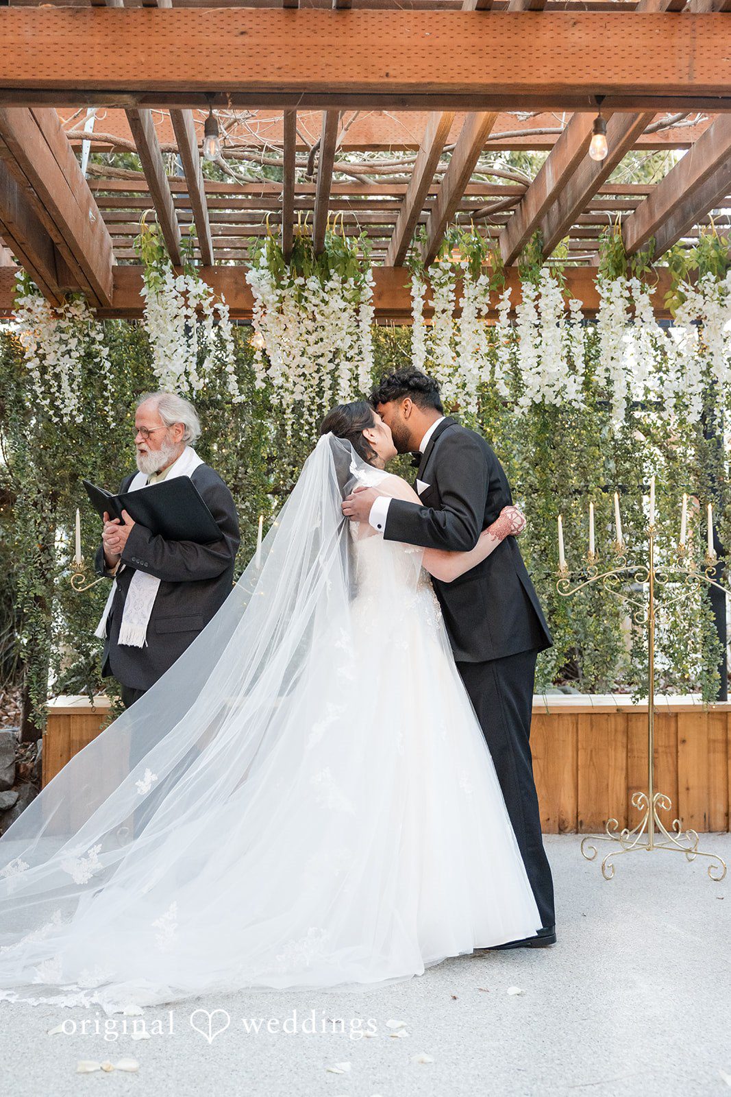 Romantic wedding kiss at the ceremony altar