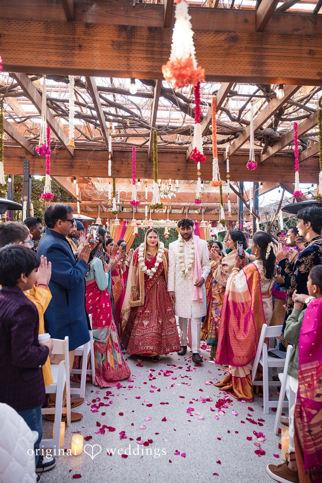 Taylor + Yash Couple walking after the ceremony through guests