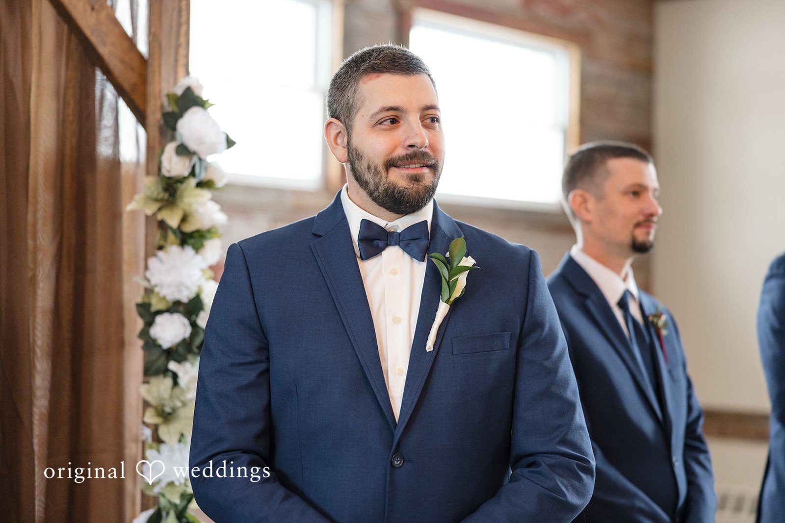 Alia + Lance Groom smiling at the altar with a groomsman standing behind him.