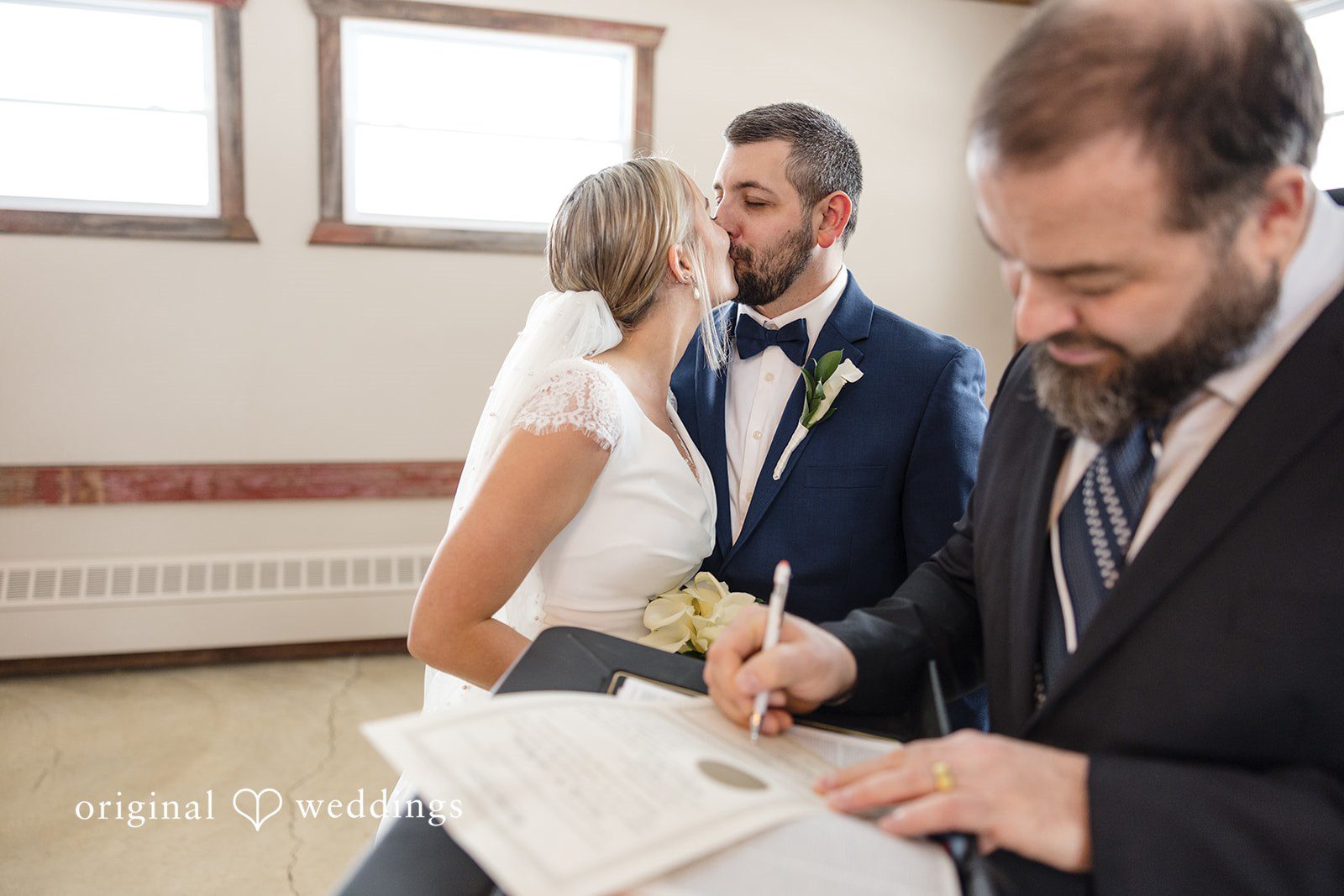 Alia + Lance Bride signing the marriage license with the groom looking on.