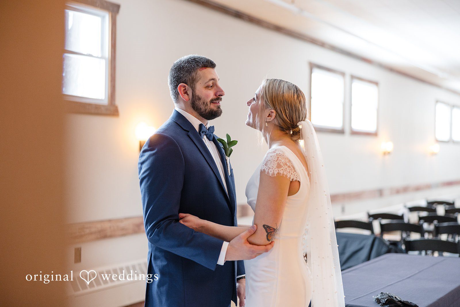 Alia + Lance Bride and groom smiling at each other while holding hands.
