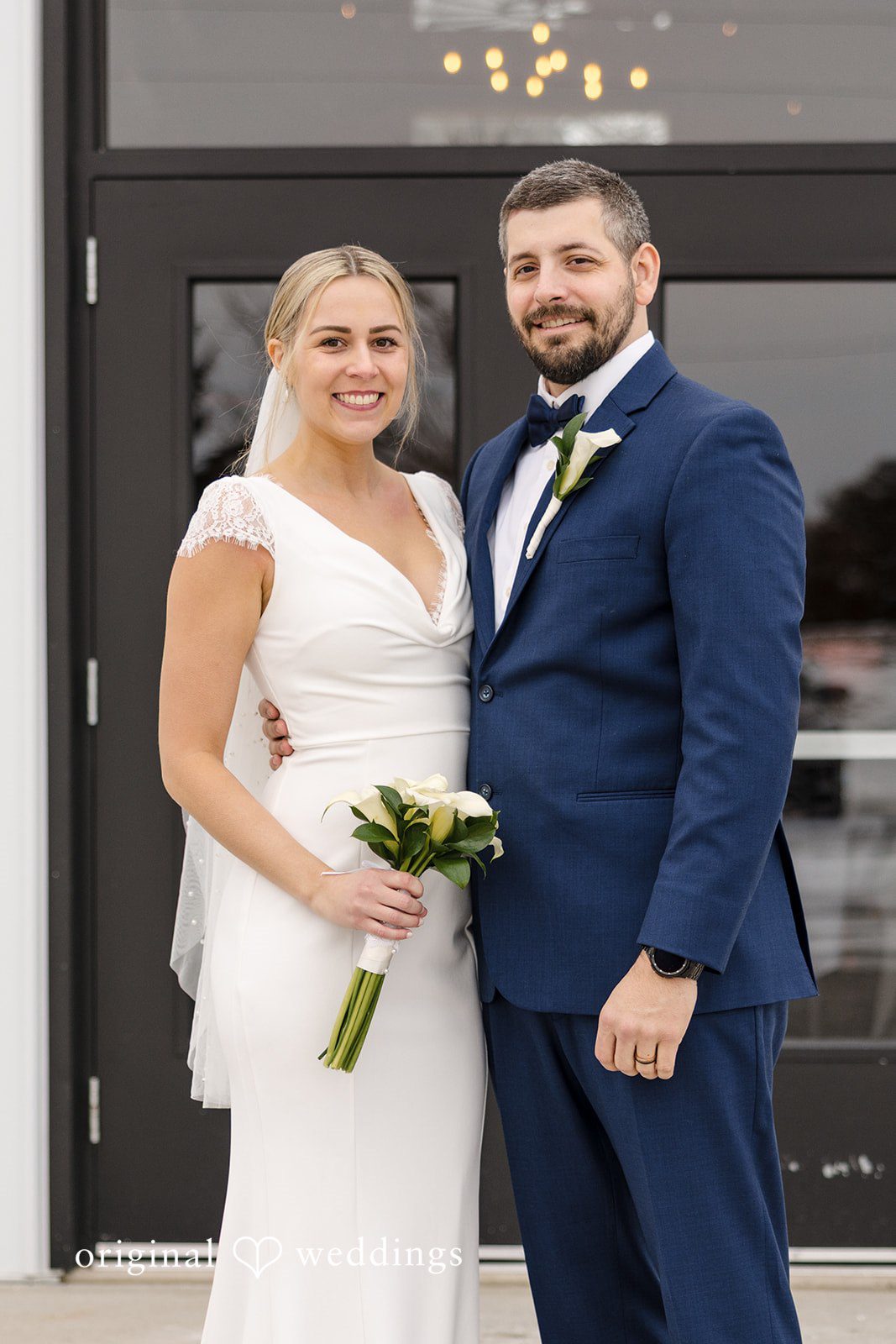 Alia + Lance Bride holding a bouquet posing alongside the groom.