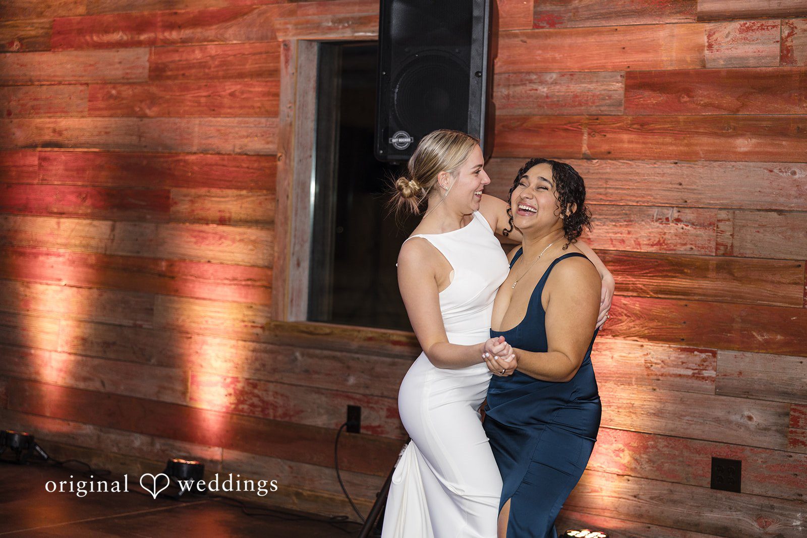 Alia + Lance Bride dancing and laughing with a female wedding guest.