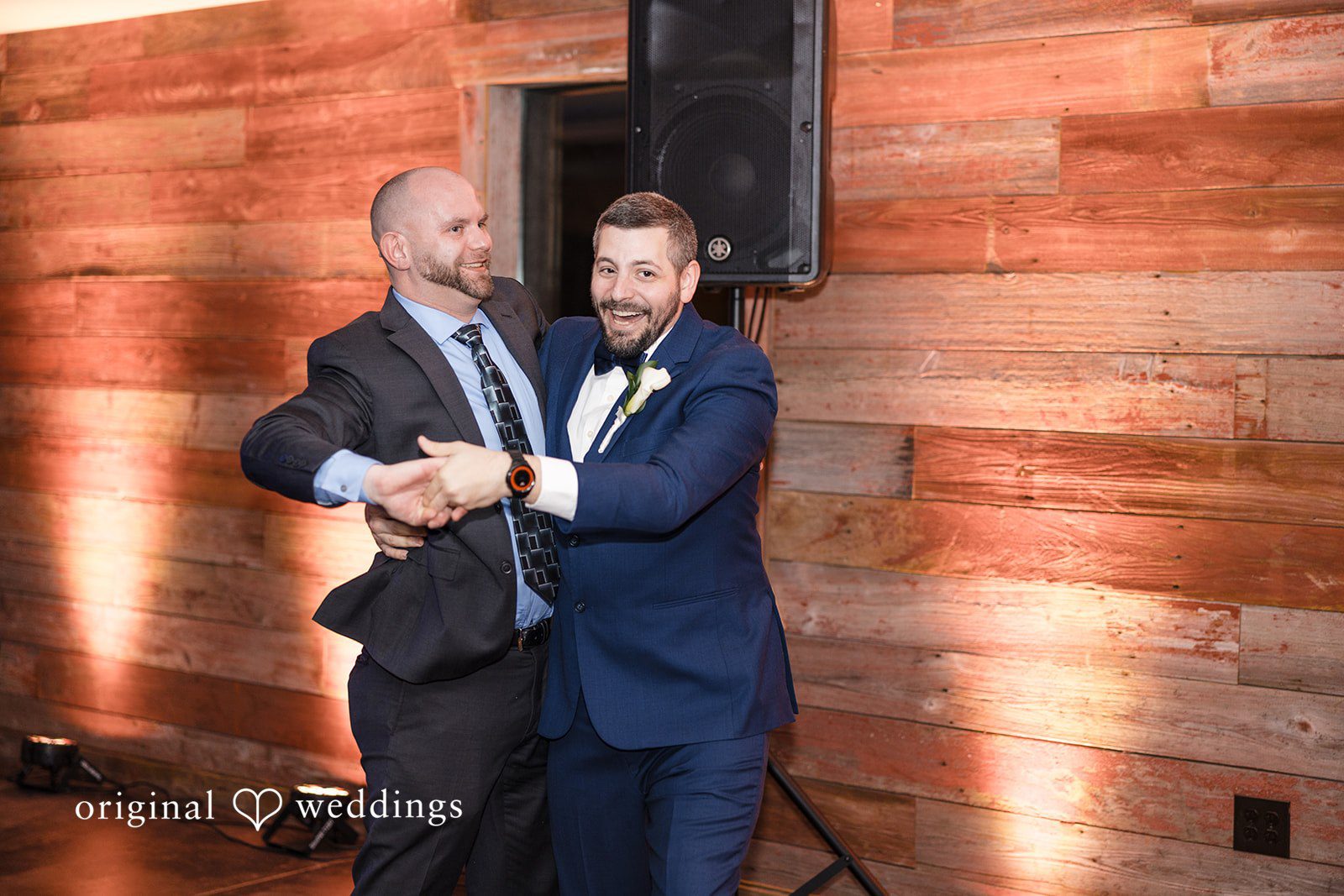 Alia + Lance Groom laughing and dancing with a male wedding guest.