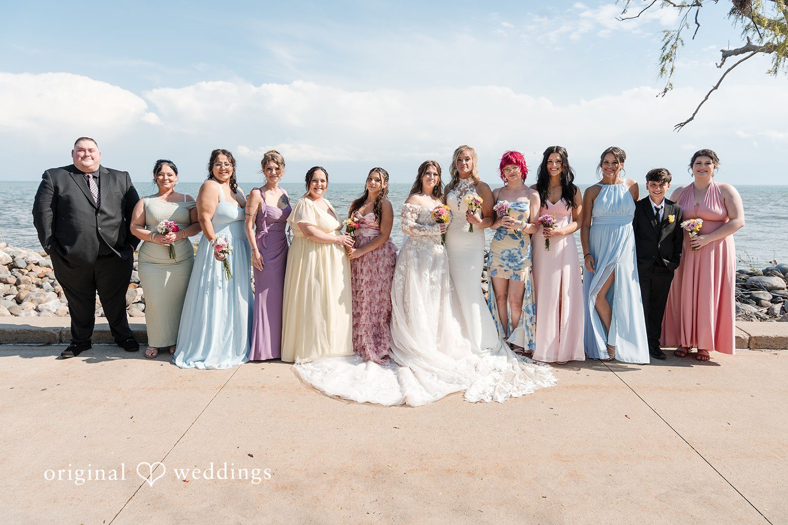 Wedding group photo with guests celebrating the couple