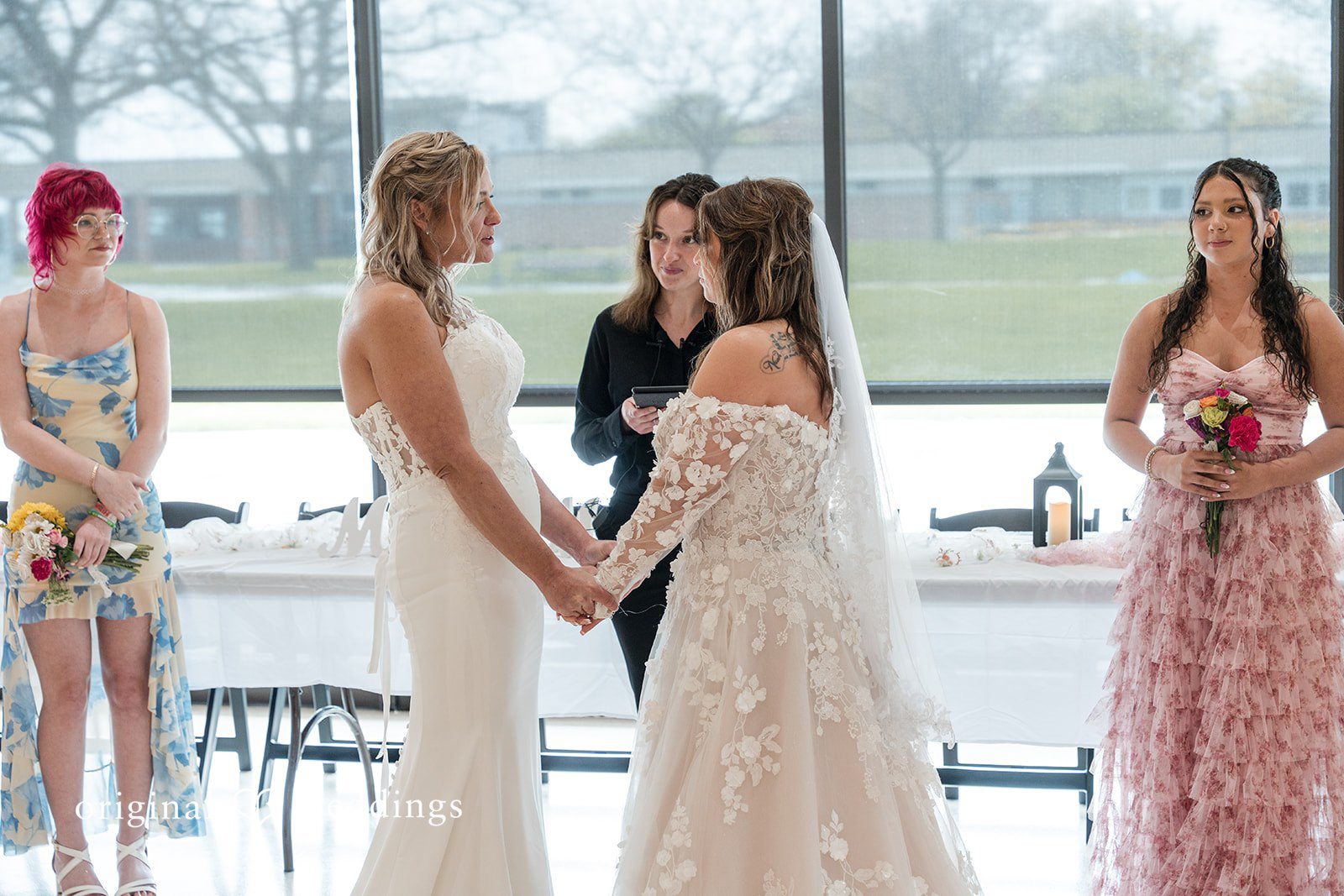 Indoor ceremony setup with large glass windows overlooking the beach