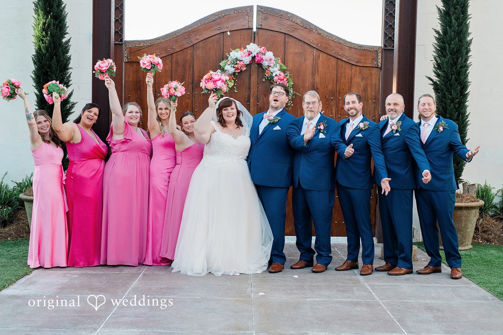 Hilary + Thomas Our Orlando wedding photographers captured a stunning portrait of the couple and their bridal party at Venue 650