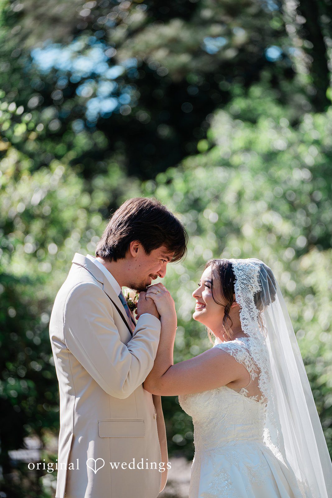 Beautiful wedding gesture of groom kissing bride’s hand