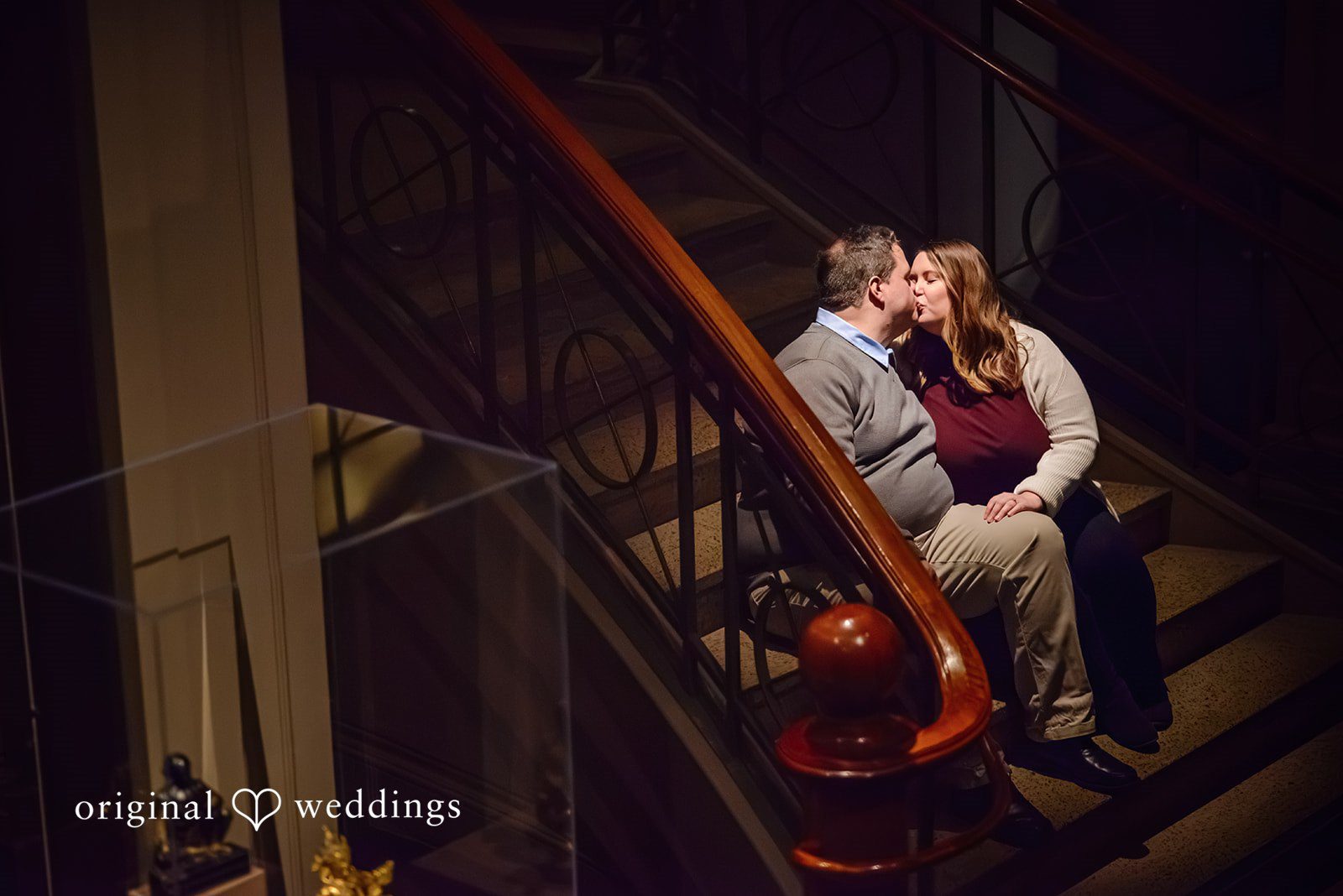 Nicole + Greg The couple shares a romantic kiss on the stairs