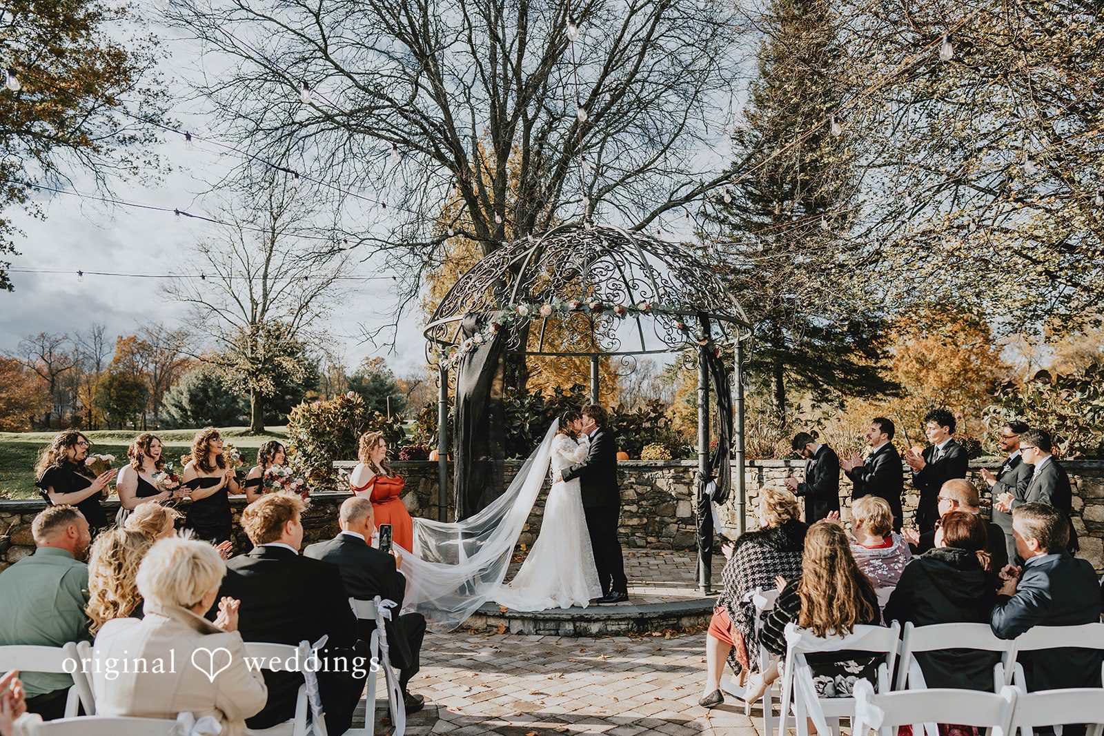 Loving bride and groom sharing romantic kiss at West Hills Country Club