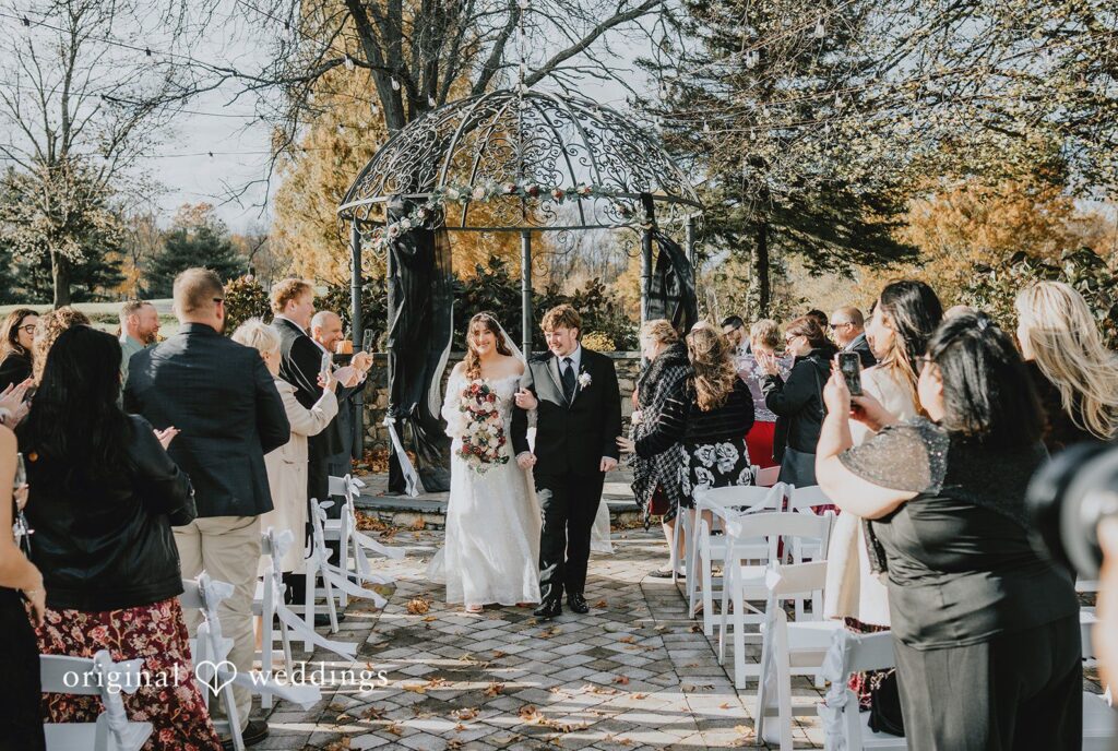 New York wedding photography at West Hills Country Club capturing couple walking back together smiling by Original Weddings