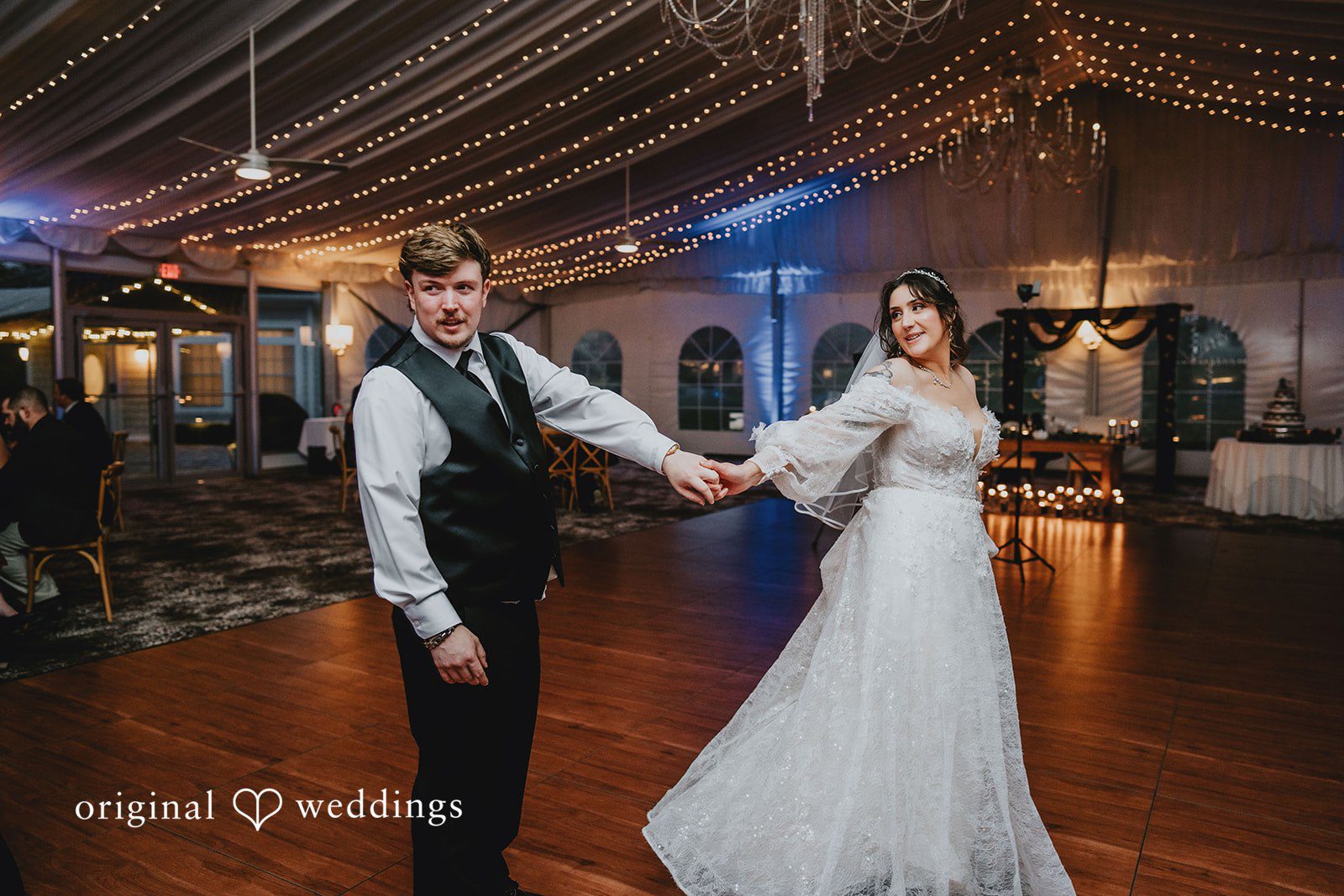 Loving bride and groom holding hands at West Hills Country Club