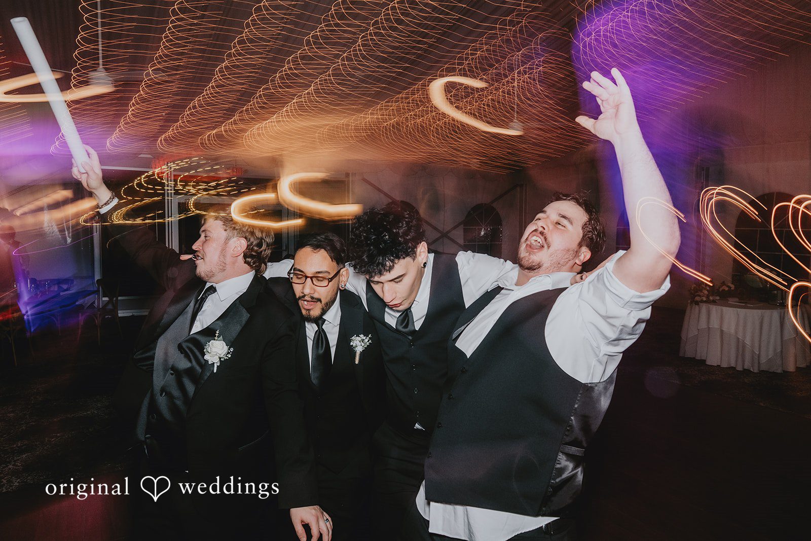 Groom dancing with groomsmen during wedding reception at West Hills Country Club