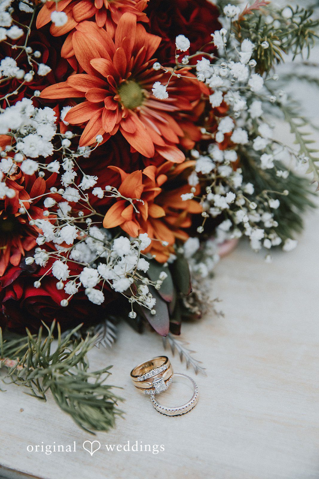 Romantic wedding ring detail shot with elegant floral arrangement at Western Sky