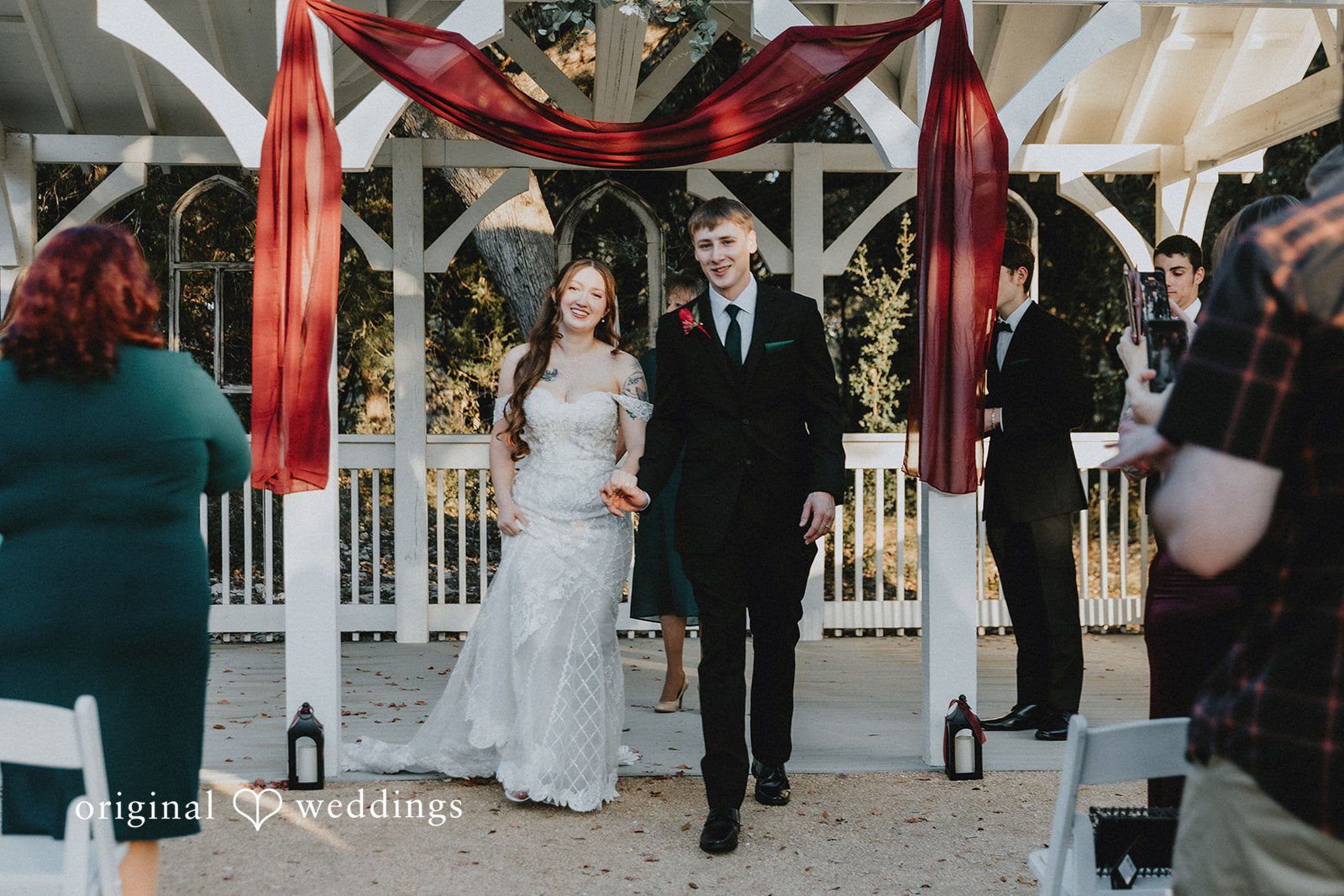 Bride and groom walking together after ceremony at Western Sky captured by San Antonio wedding photographers from Original Weddings