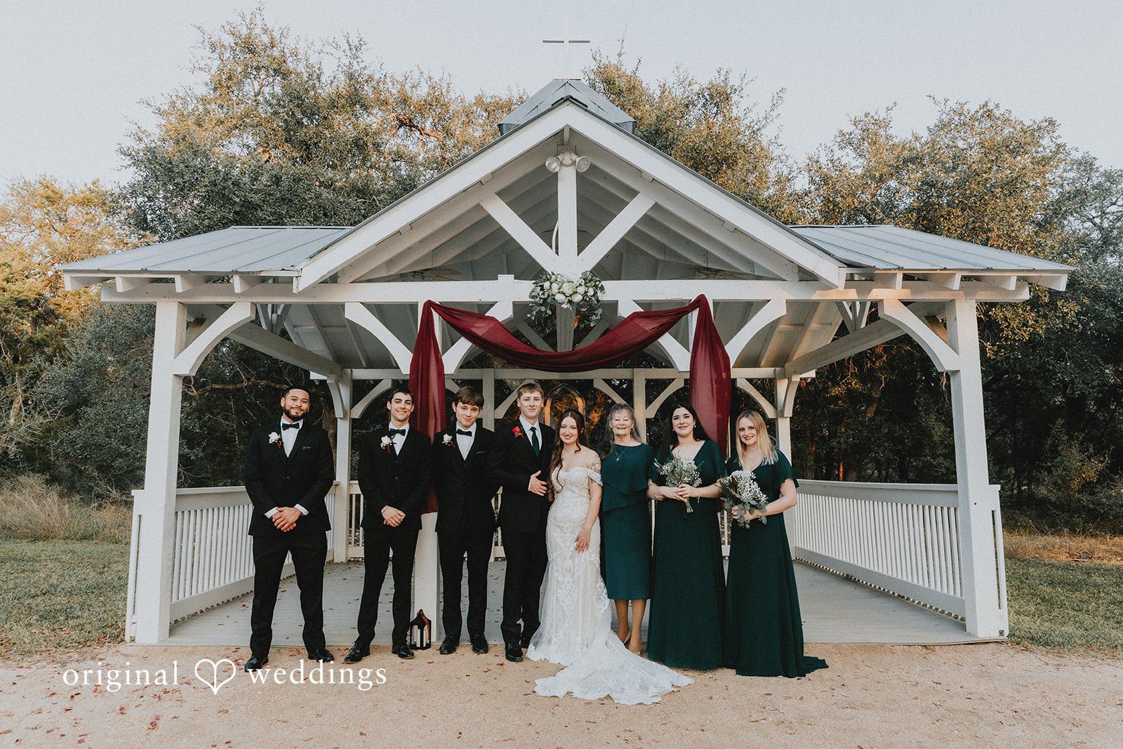 Bride and groom standing with bridesmaids and groomsmen