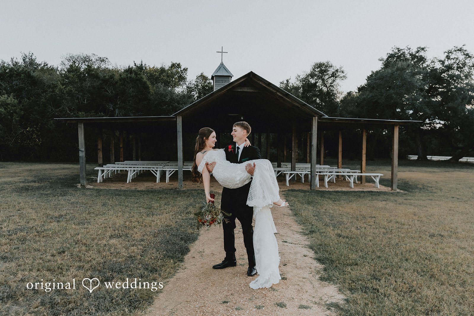 Groom carrying the bride at Western Sky captured by San Antonio wedding photographers from Original Weddings