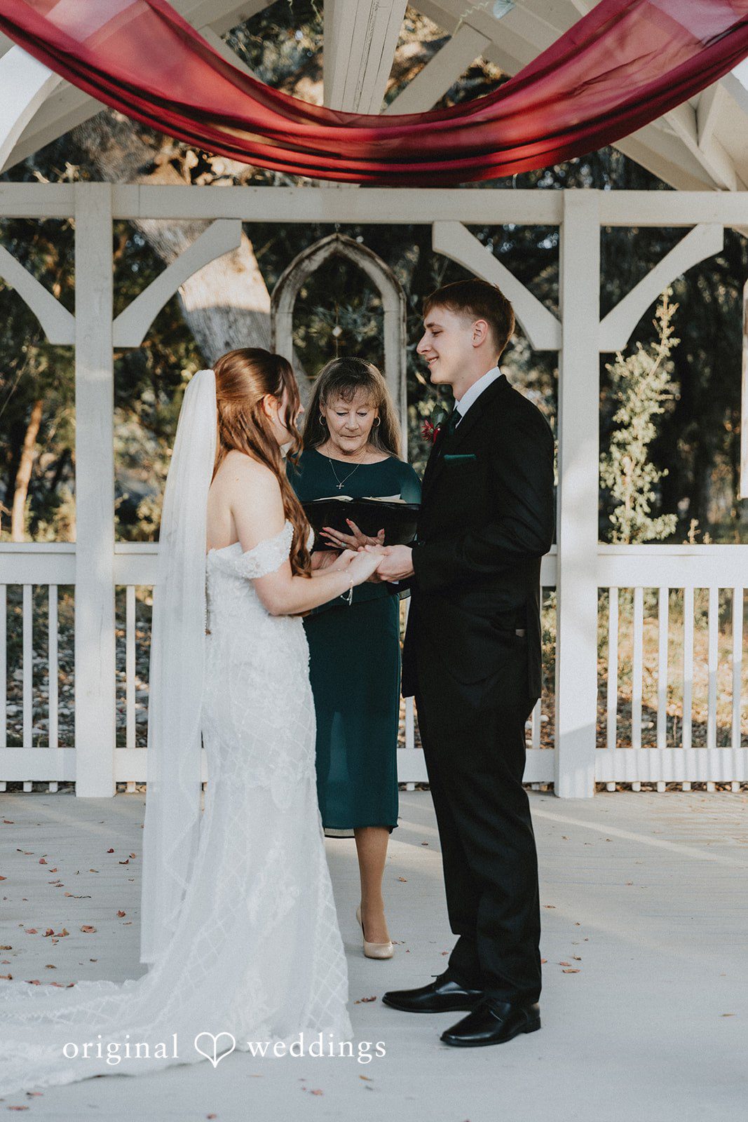 Bride and groom holding hands during wedding ceremony at Western Sky wedding venue