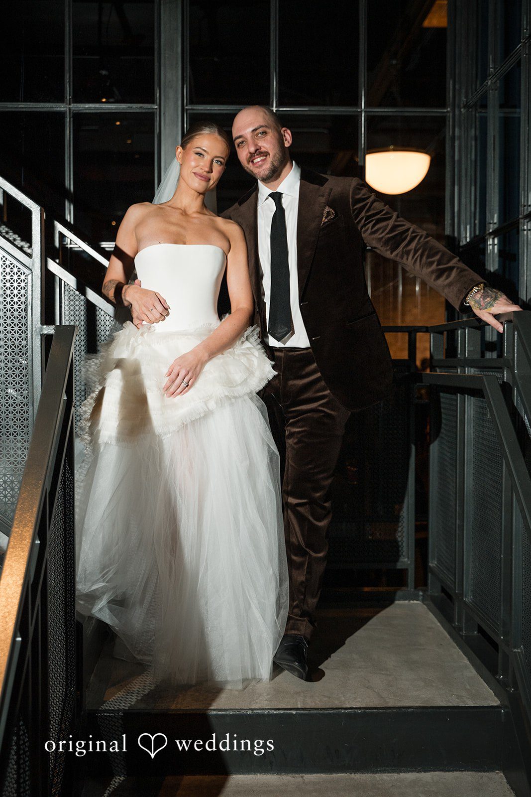 Erin + Zack A portrait of the couple by the stairs