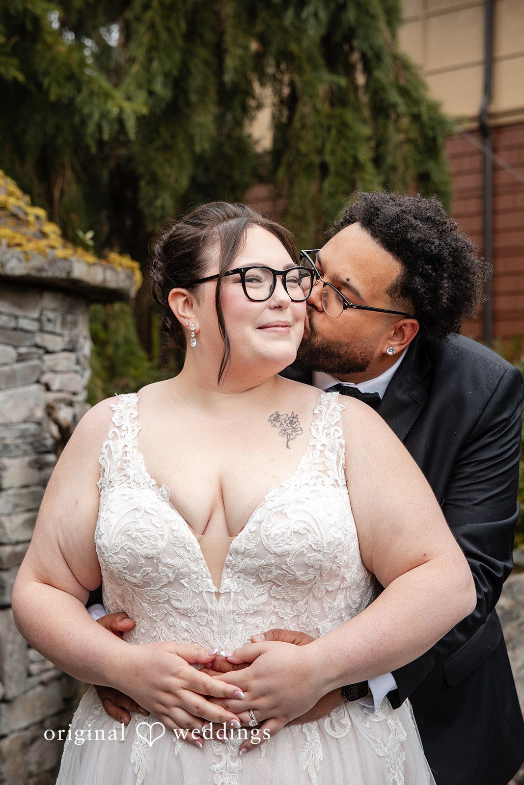 Seattle Wedding Photographers capturing groom kissing bride’s cheek at Willows Lodge by Original Weddings