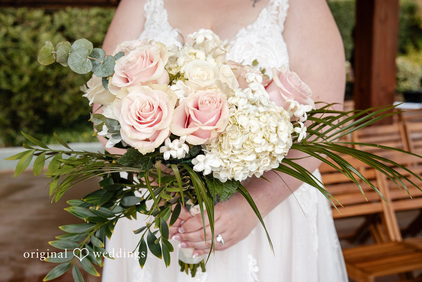Elegant bride holding floral bouquet detail shot