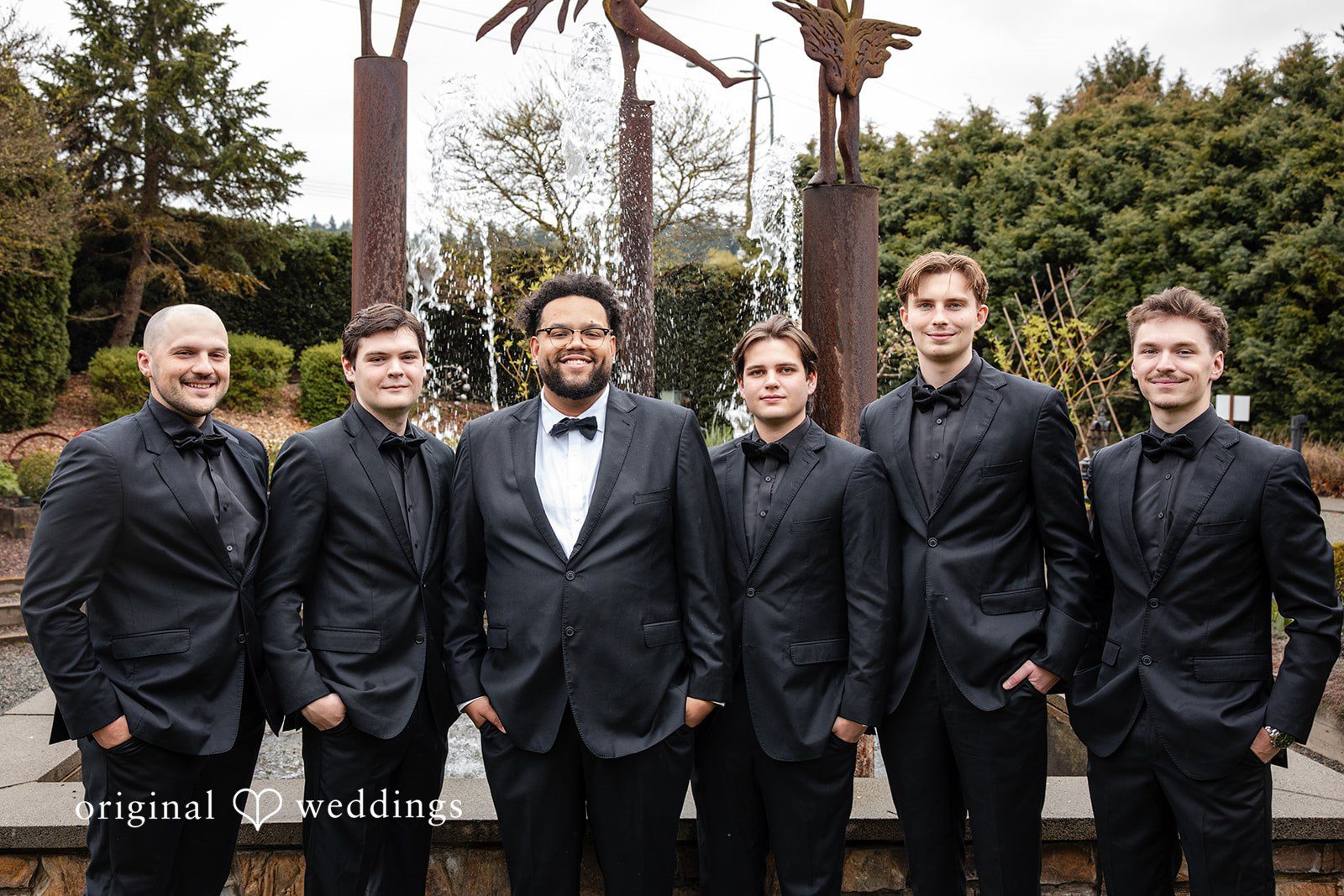 Elegant groom standing with groomsmen group