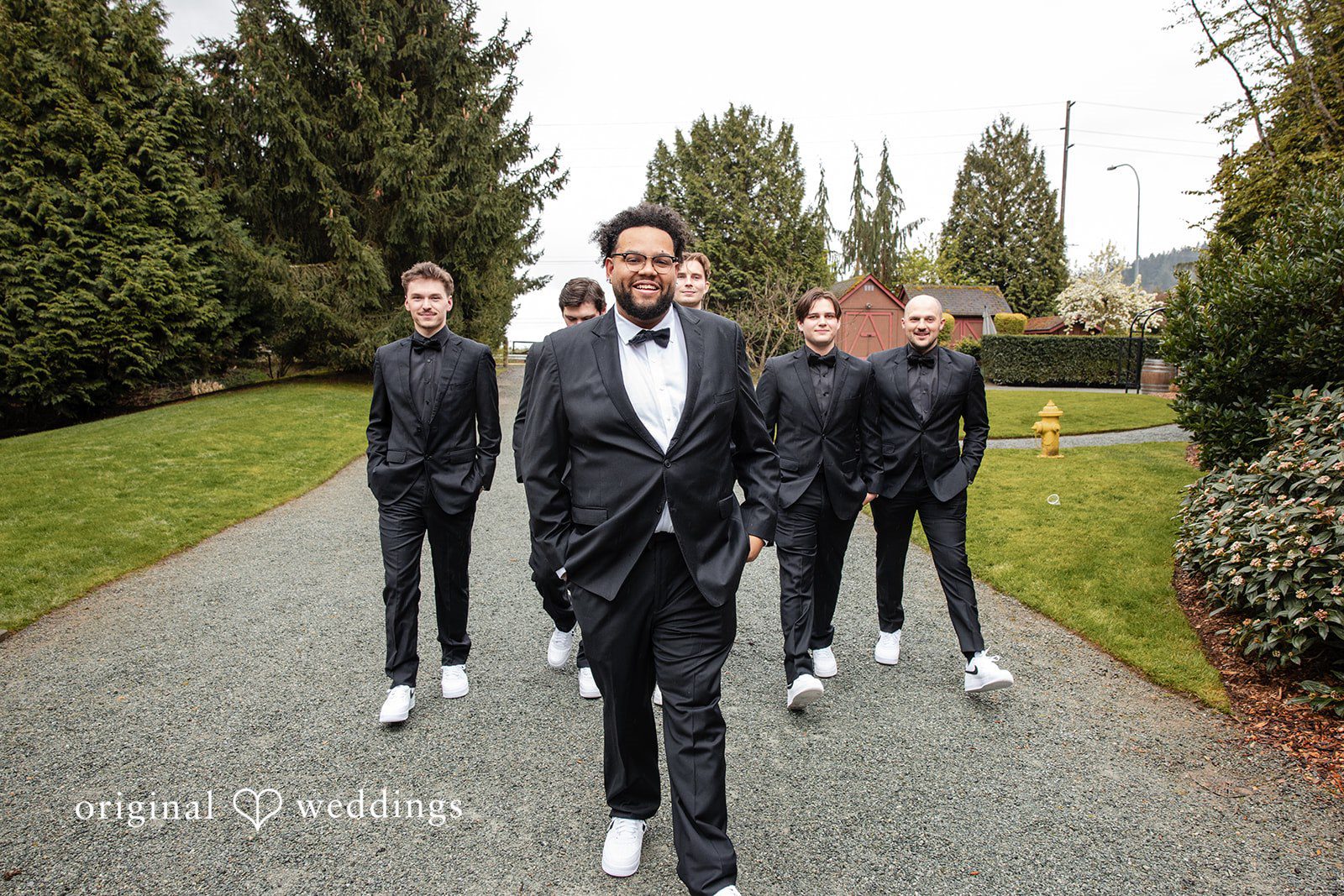 Joyful groom squad walking shot