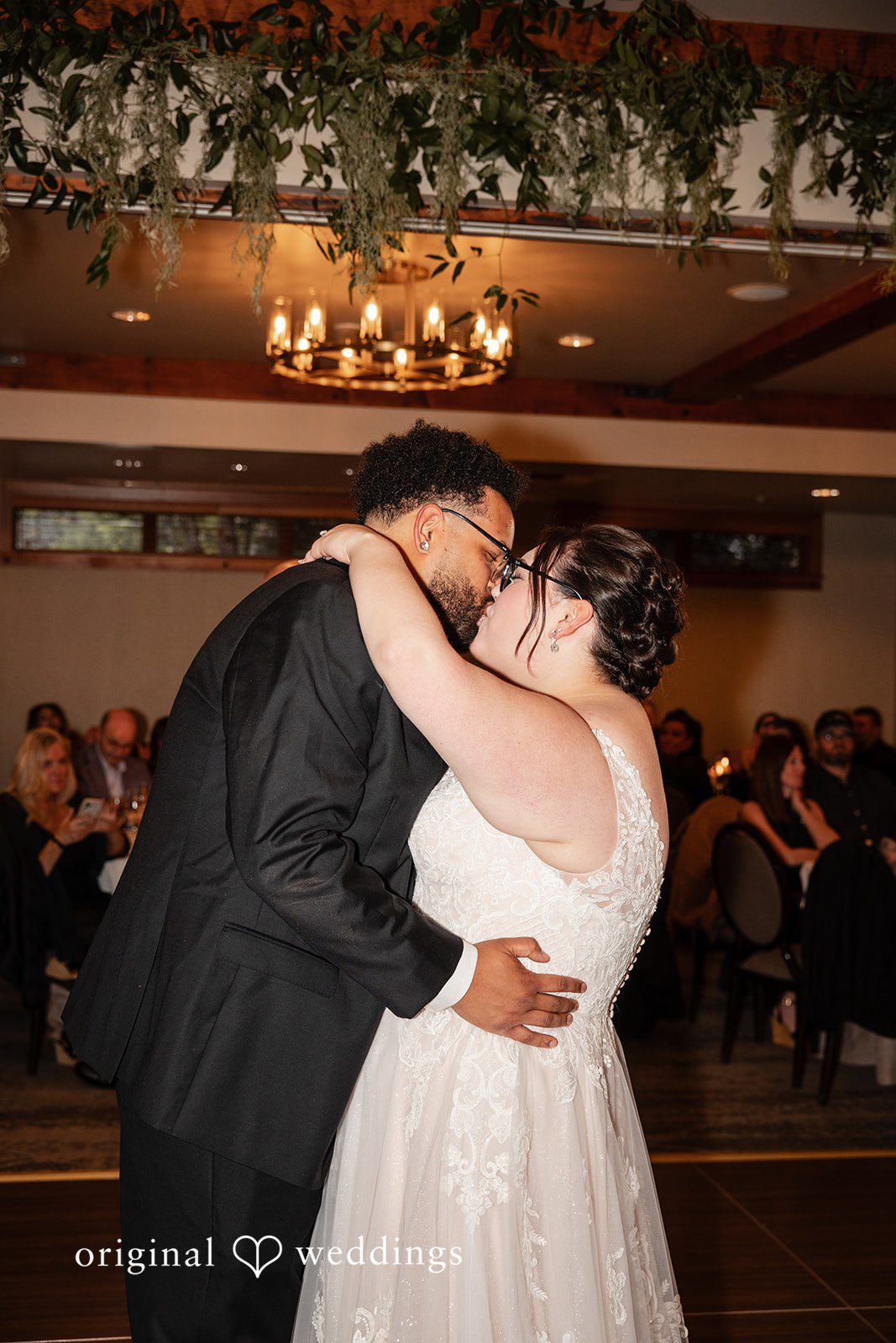 Seattle Wedding Photographers capturing bride and groom dancing and kissing at Willows Lodge by Original Weddings