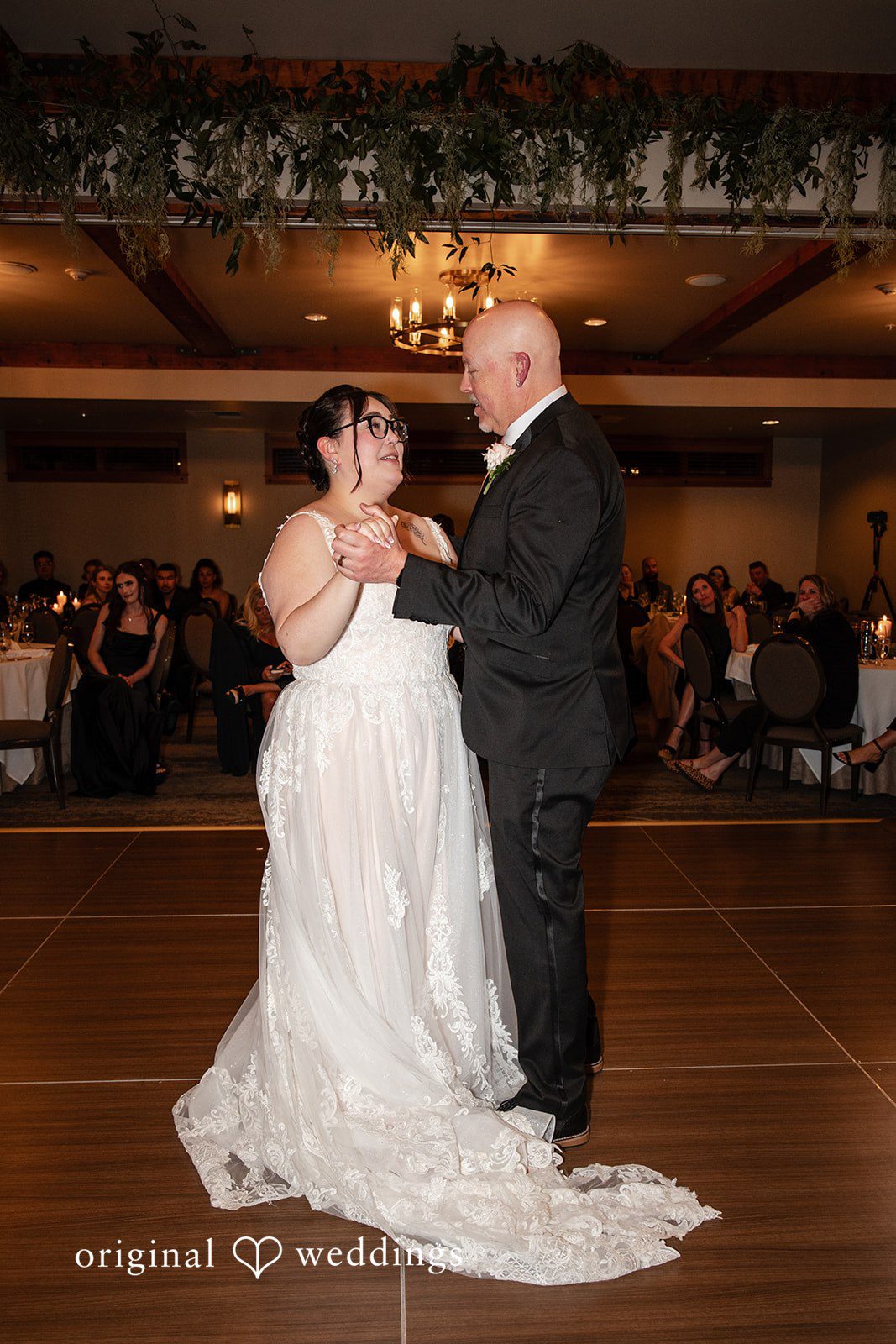 Elegant bride dancing with someone at Willows Lodge