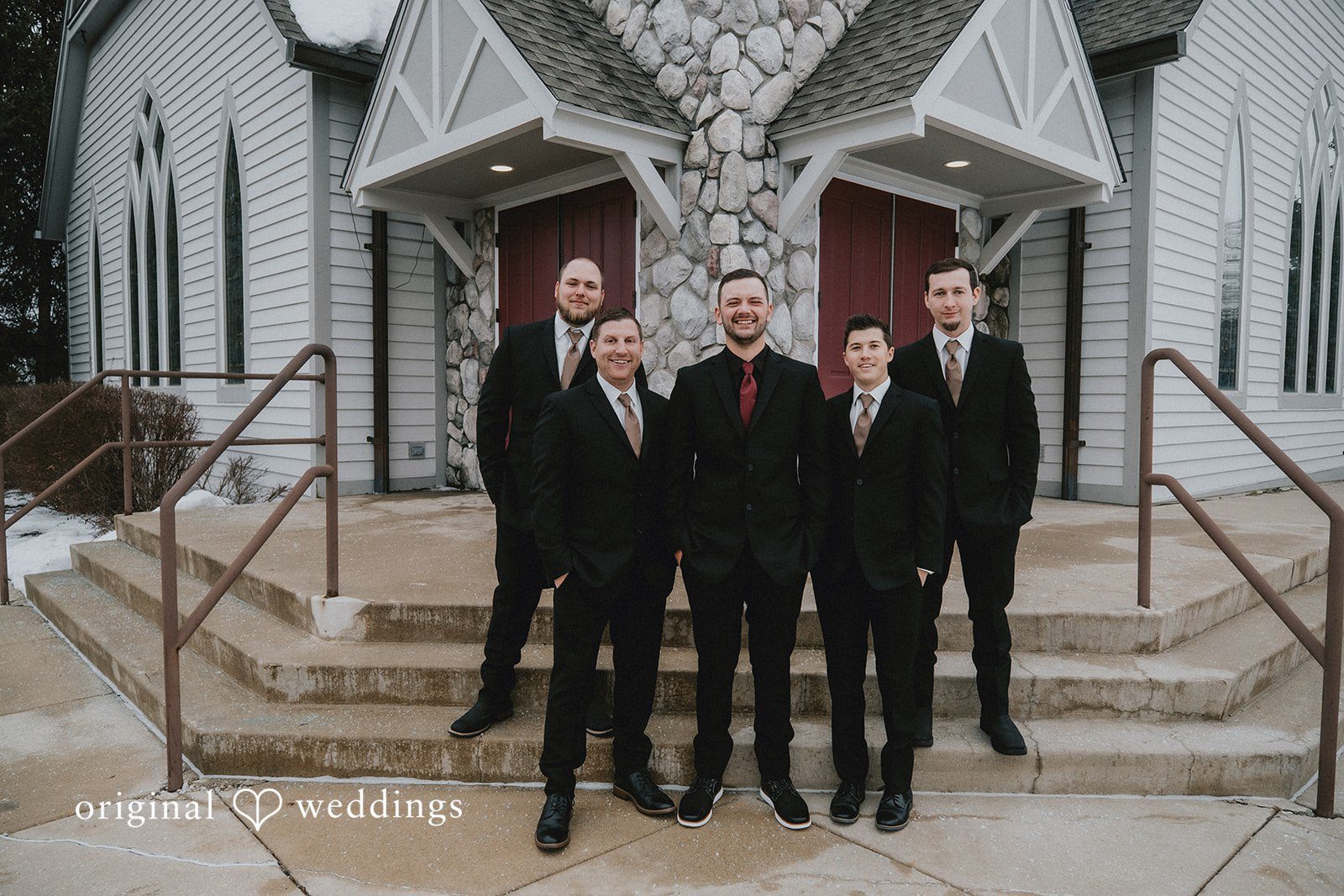 Sarah + Justin A groom and groomsmen in black suits pose together at Aberdeen Manor.