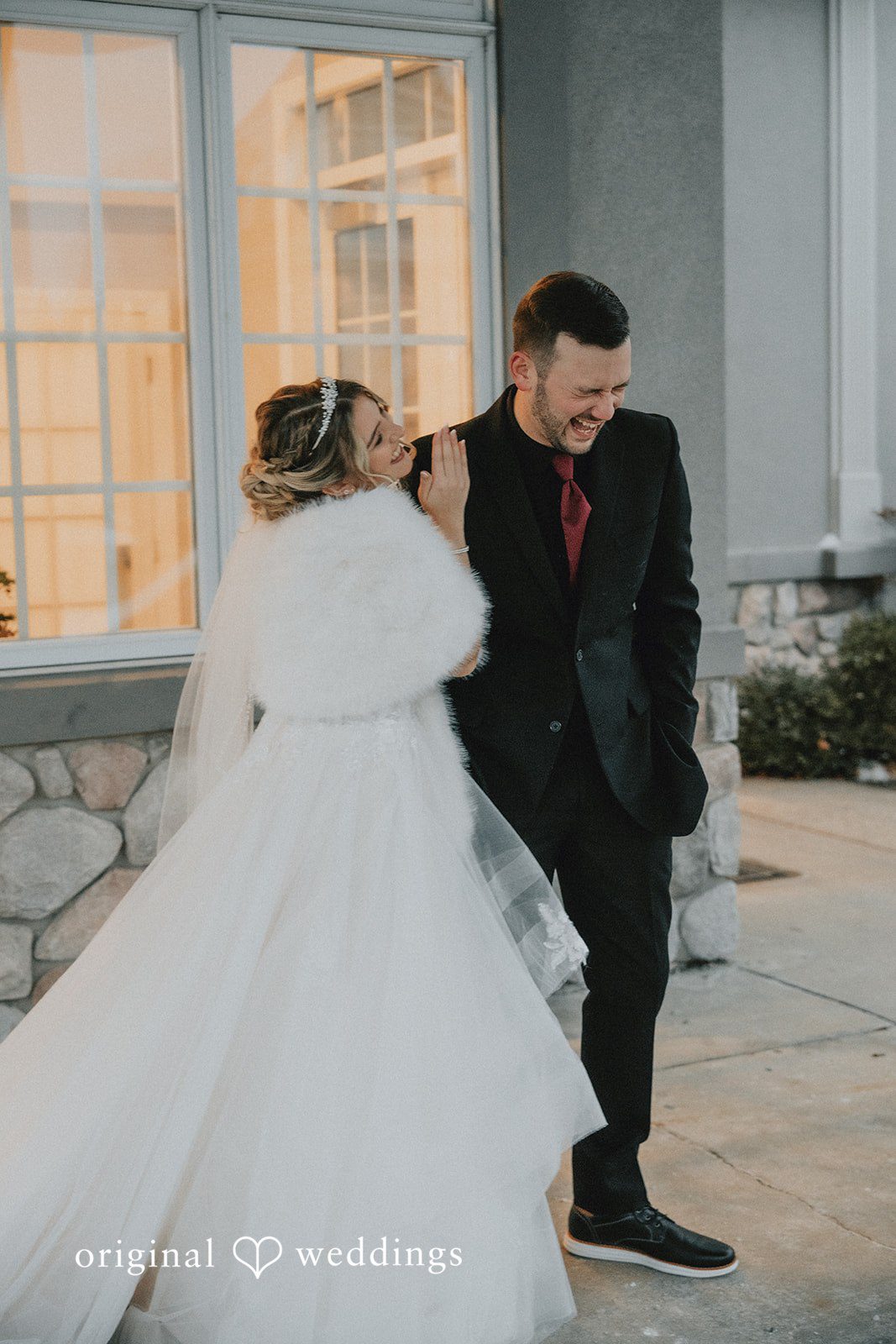 Sarah + Justin Bride and groom laughing together in the snow, viewed from behind at Aberdeen Manor.